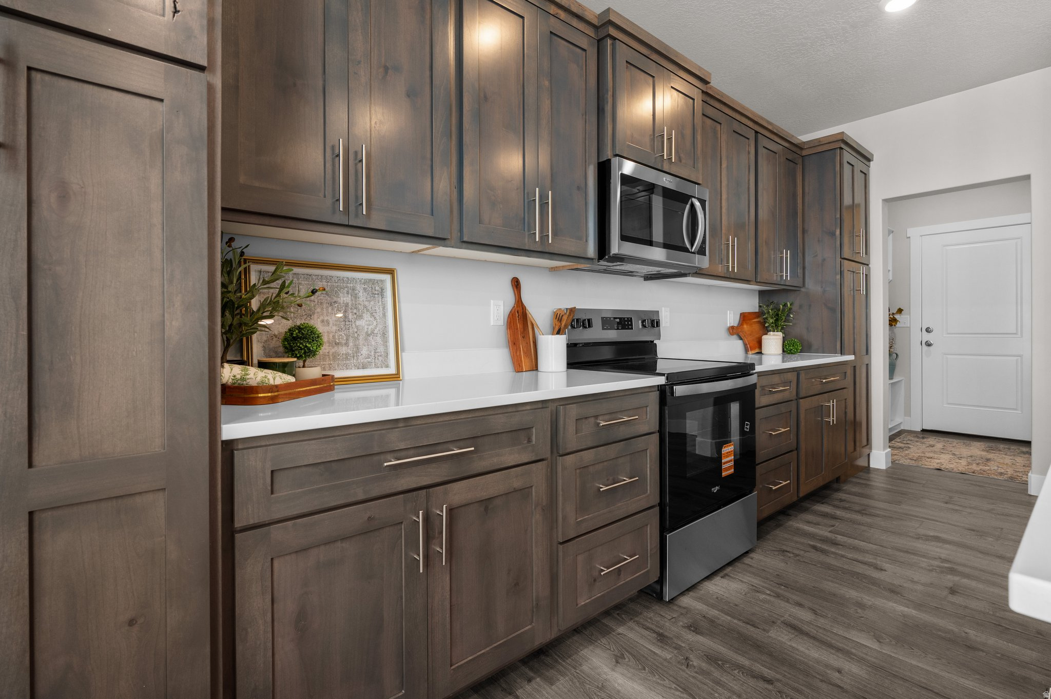 Welcome to Midland Square Townhomes in Roy! These BRAND-NEW 3-bedroom, 2.5 bathroom, townhomes feature 9' ceilings on the main level, granite or quartz countertops, soft-close cabinets, a spacious walk-in pantry with an outlet for appliances, ceiling fan in the living room, abundant kitchen storage and counter work space, LPV throughout main floor, under the stairs storage along with two linen closets upstairs, mudroom area, and 2-car garages. Partially fenced backyard spaces provide added privacy and functionality. The generously sized primary bedrooms include a walk-in closet, ceiling fan, with select homes offering double vanities and large showers, while others feature single vanities with separate tub/shower combinations. Choose from floor plans with unfinished basements for future growth OR options without basements to fit your needs. Enjoy convenient access to shopping, dining, schools, parks, and the FrontRunner. Midland Square offers comfortable, low-maintenance living in a welcoming, community-focused neighborhood.