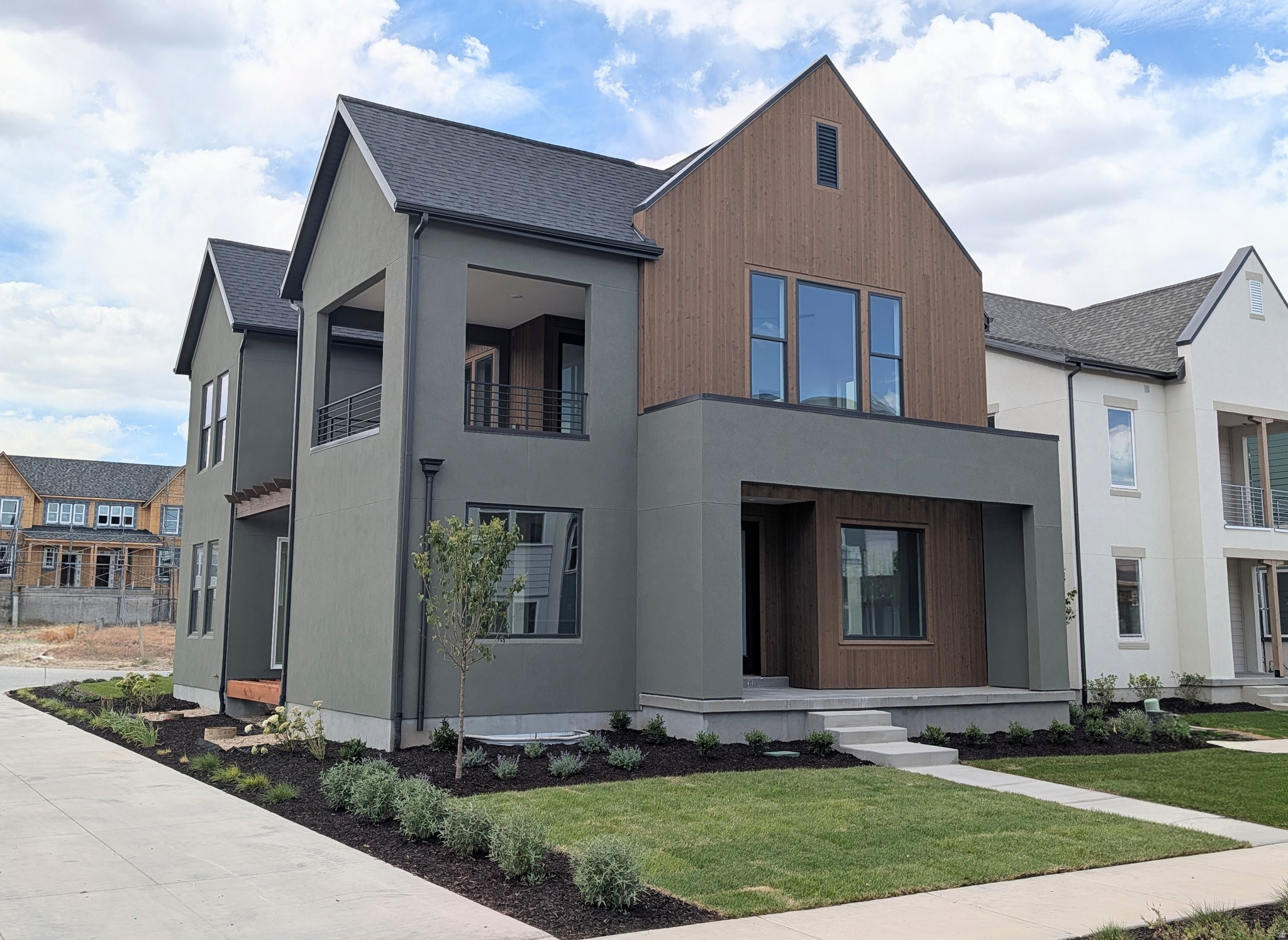 Nearing completion of this highly sought-after "Adventurer" floor plan! This home showcases the beautiful cedar wood exterior and includes a FINISHED basement. Great livability from multiple outdoor living spaces designed to extend your living area beyond the walls of the home. The price includes impressive designer upgrades such as 9-foot ceilings on all levels, a cozy fireplace, modern railing, and a coveted indoor/outdoor layout with oversized sliding glass doors connecting the Great Room and Kitchen to the patio, perfect for entertaining. A bright main-level office is filled with natural light from abundant windows, creating an ideal space for work or relaxation. Upstairs, the dreamy Primary Suite features a private, covered balcony that is hot tubready, along with a luxurious en-suite bathroom complete with a standalone soaking tub and a spacious walk-in shower. Photos of Actual Home. Estimated completion: Late July 2026.
