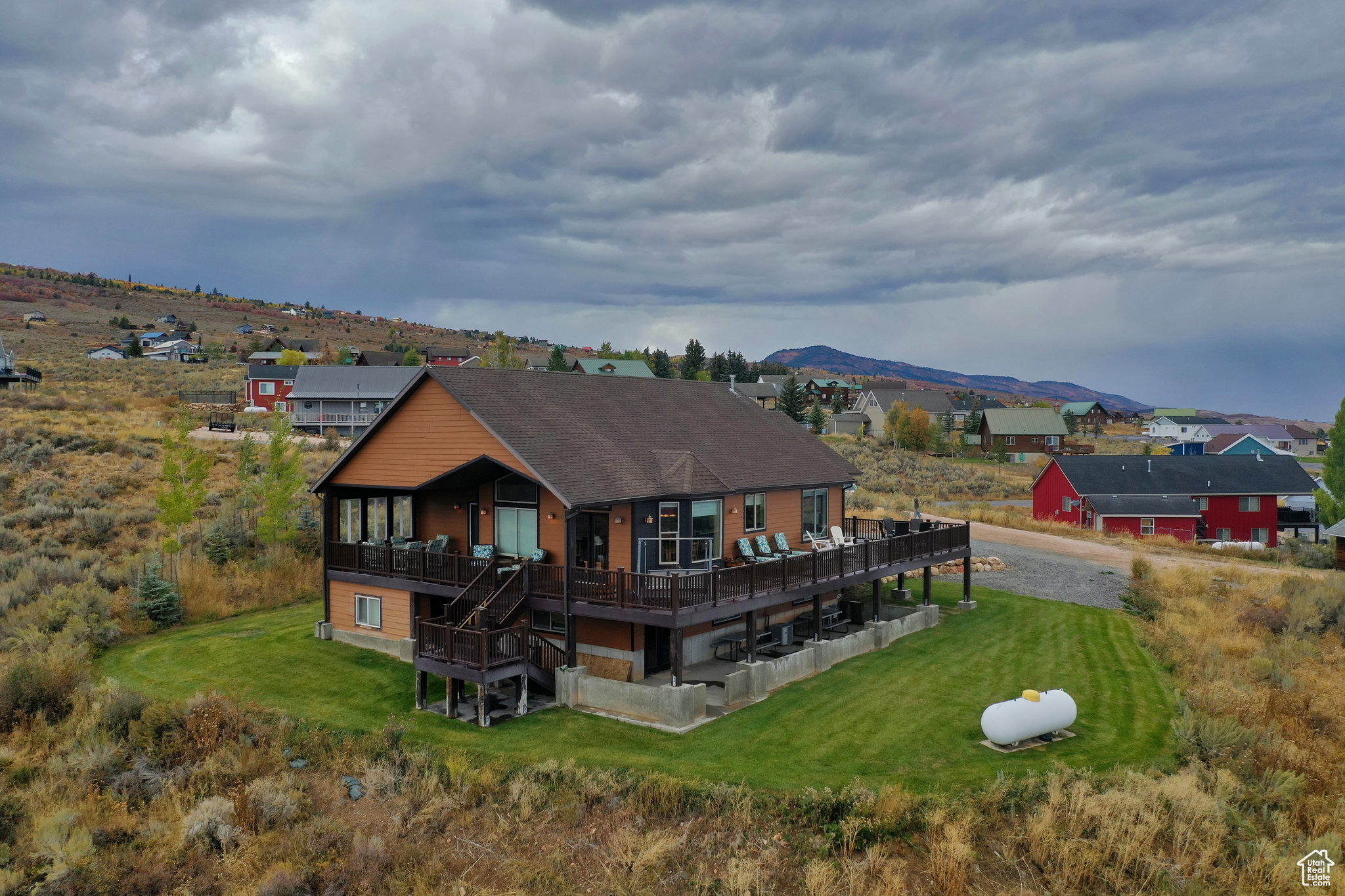 Cozy and very well-maintained cabin in the lower Sweetwater Subdivision, featuring rustic accents and warm mountain dcor. This inviting retreat offers six bedrooms and three bathrooms, with a vaulted great room showcasing a stunning floor-to-ceiling rock fireplace with a timber mantel. The open kitchen, dining, and great room layout creates the perfect gathering space for family and friends. The lower level includes a spacious living room and game room, ideal for relaxing or entertaining. Enjoy beautiful views of Bear Lake and the Bear Lake Golf Course, and direct access to the Hodges CanyonSink Trailhead right from the front door. The property also features a two-car garage with epoxy floors, providing a clean and durable space for vehicles and storage. Conveniently located just five minutes from Bear Lake State Park Marina and twenty minutes from Beaver Mountain Ski Resort. Optional amenities are available for an additional fee at Ideal Beach, including two heated seasonal pools, two year-round hot tubs, basketball and tennis/pickleball courts, mini golf, a playground, and a beautiful sandy beach with boat rentals. Short-term rentals are allowed, making this property an excellent investment or vacation retreat. Sold fully furnished and completely turn-key, this charming cabin is ready for you to start enjoying Bear Lake living immediately.