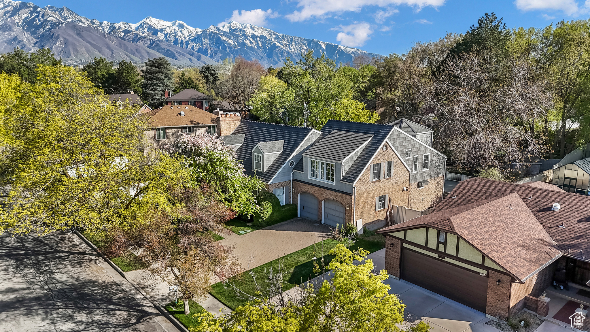 This beautiful crafted home is rich in charm and character, offering timeless details and luxurious finishes throughout. Located in desirable neighborhood of Holladay, it combines upscale living with an unbeatable setting. Thoughtful design features include wood floors throughout, crown molding in the living and dining rooms, copper-roofed bay and bow windows, durable Owens Corning slate roof. The gourmet kitchen is equipped with 2 Wolf ovens, sub zero refrigerator, granite countertop and plenty of storage space. Stone flooring enhances the main and upper level bathrooms, and double laundry rooms add convenience. Enjoy year round relaxation in the sunroom with its spa, limestone floor, and bamboo ceiling. The private backyard boasts a sparkling swimming pool, brick pool deck, spacious deck and upper level balcony overlooking the pool. Recent updates include new furnace, adding to the homes comfort and efficiency.