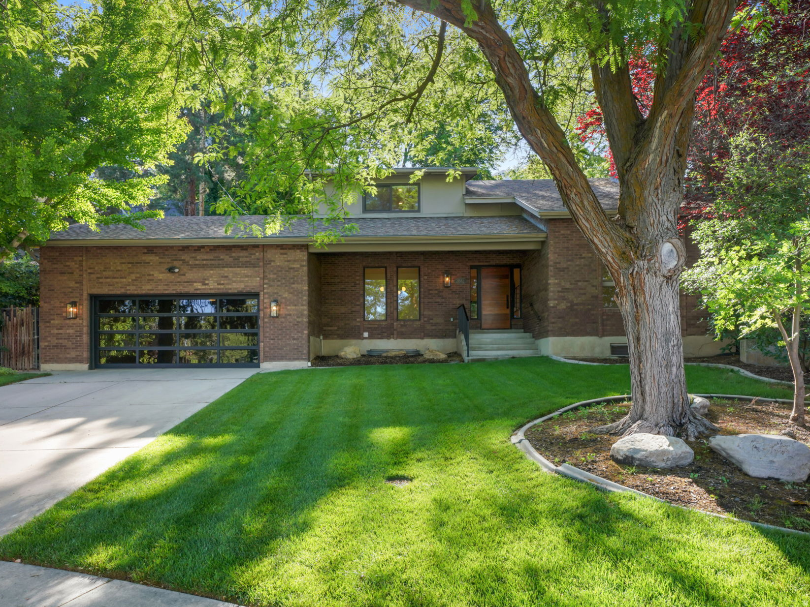 Beautiful modern home located on a quiet cul-de-sac in Holladay's Heather Circle. This fully updated 5-bedroom, 4-bathroom home offers mountain views, mature trees, and an established neighborhood setting. Thoughtfully remodeled throughout, the home blends quality finishes with functional living spaces. Inside, you'll find high ceilings, large windows, marble countertops and backsplash, new hardwood floors, custom cabinetry, Restoration Hardware finishes, Thermador appliances, a new garage door, and smart home features. The spacious primary suite features a large walk-in closet and a beautifully updated bath. The upstairs finishes off with 2 additional bedrooms and jack and jill bathroom and custom built-ins. Lower level features 2 additional bedrooms and a spacious family room. The private, terraced backyard is surrounded by towering mature trees and includes a large patio just off the kitchen, creating an ideal space for outdoor dining and entertaining. Move-in ready and extensively updated, this home is a rare opportunity in a beautiful Holladay setting while remaining conveniently close to freeway access, downtown Salt Lake City, Salt Lake International Airport, and year-round outdoor recreation, as well as walking distance to the new and vibrant Holladay village with shops and restaurants.