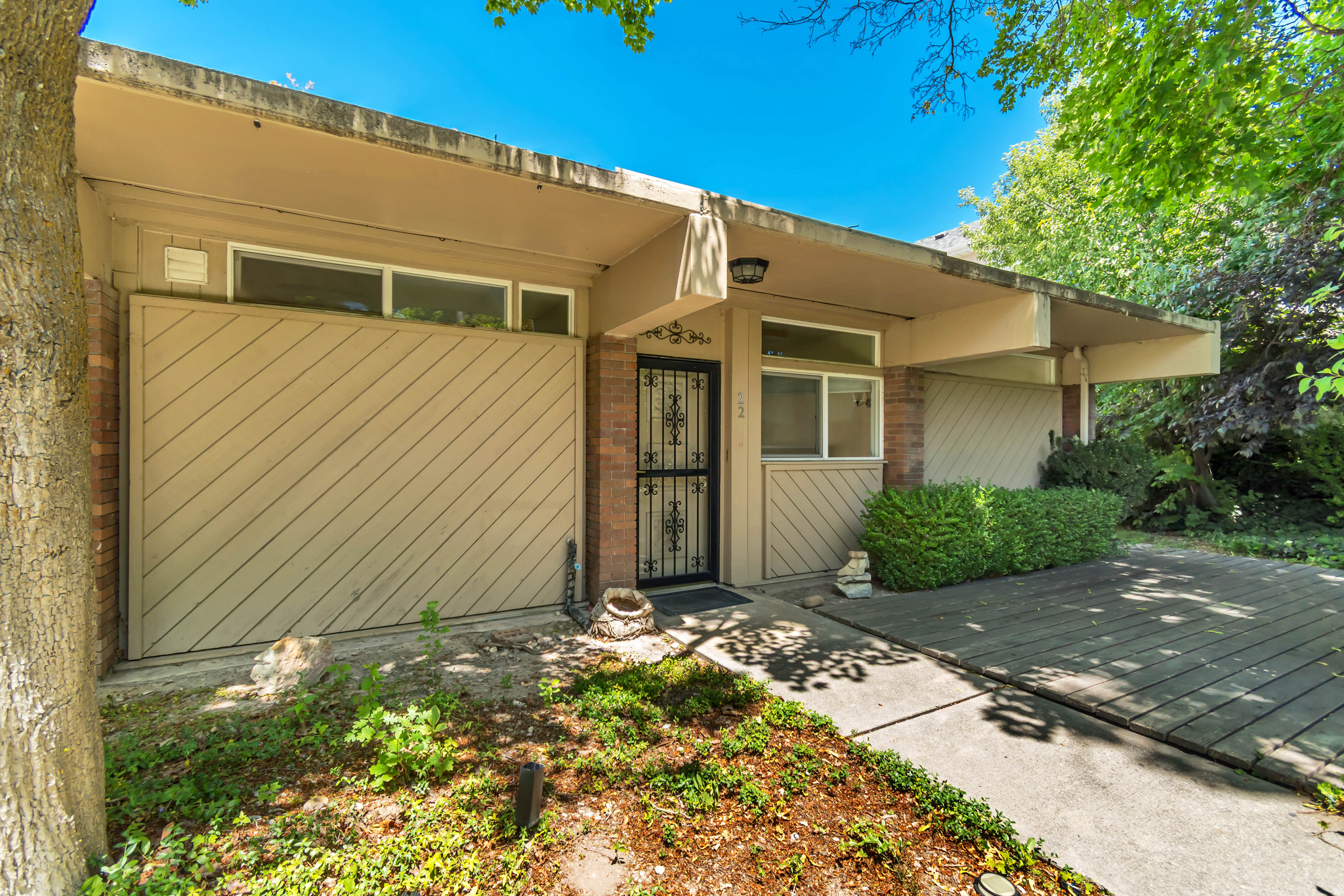 Rarely available main level condo with completely private outdoor patio area! Perfect if you are looking for quiet, low maintenance living without neighbors above or below.  This gem has tons of cosmetic potential and features an open layout filled with natural light from the huge windows, creating a warm and airy feel throughout. Conveniently located close to schools, shopping, the stadium, university, restaurants, and easy freeway access, making commuting and daily living a breeze.