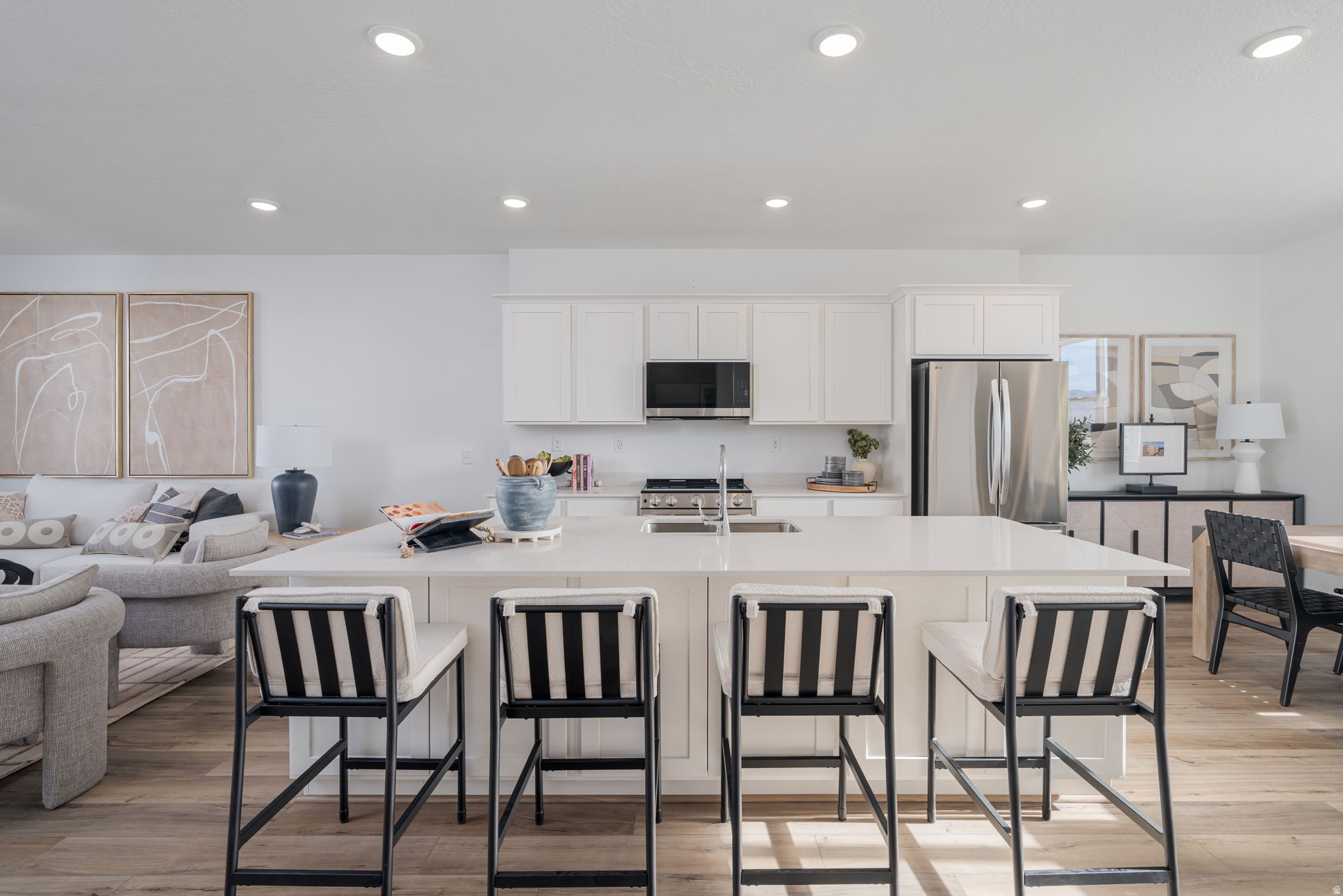 Homesite #306 - End unit!!! The Keansburg offers a smart layout with stylish finishes throughout. This 4-bedroom, 3.5-bath home features 1,986 sq. ft. of thoughtfully designed living space, perfect for both everyday living and entertaining. The main level showcases an open-concept design with LVP flooring throughout, creating a seamless flow between the kitchen, dining, and living areas. The kitchen features white cabinetry, white quartz countertops, and a functional layout that balances style and efficiency.  Upstairs, the primary suite provides a comfortable retreat, while additional bedrooms offer flexibility for guests, a home office, or hobbies. With 3.5 bathrooms, this home is designed to accommodate a variety of living needs with ease. Projected completion August 2026. *Photos of model home, options & finishes may vary*