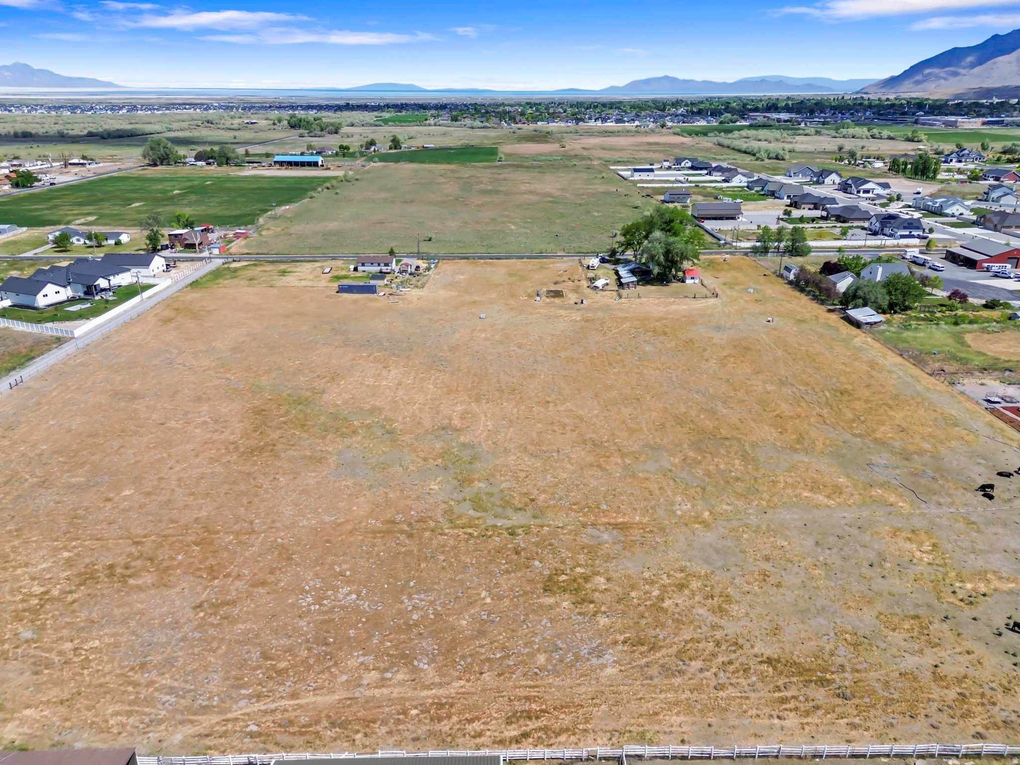 Prime opportunity in Erda, Utah offering approximately 7 acres with exceptional development potential. This property can be used as a private estate/ranch or subdivided into up to seven 1-acre lots, creating a small residential neighborhood. The seller has a preliminary plat drafted of a potential future development to give you an idea of what is possible. Providing flexibility for future buyers to develop or sell each parcel separately. Included is 10.5 acre-feet of water, adding significant value and utility for future use. With its desirable location and versatility, this property is well-suited for a multi-home estate, investment opportunity, small subdivision for builder, or a shared group looking to create a private neighborhood compound. Sale is subject to final lot split and boundary adjustment to legally separate approximately 7 acres from the existing parcel.