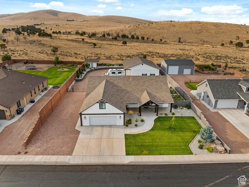 Custom Country Dream Home w/ Stunning Mountain Views. Built in 2017, 3,311sqft w/ 4 beds (2 masters), 4 baths, large 0.51 acre lot w/ an oversized attached 2-car garage (710 sqft) w/ epoxy/sealed flooring & new garage cabinets. Updated with new windows, new entry door, new LVP flooring. Large chef's kitchen w/ all the upgrades of granite countertops, custom cabinetry, built-in stove top. Get cozy by the fireplace. Fully fenced yard w/ new landscaping, sprinklers, water feature, garden boxes w/ sprinkler system & gazebo w/ an outdoor kitchen area. The heated and insulated 50x35 (1,400 sqft) 4 car double door shop is a craftsman's delight, w/ 50 amp RV hookup w/ clean out. Shop has an attached office/bedroom (w/ mini split) and full bathroom with ample storage above shop office. Come see!!!