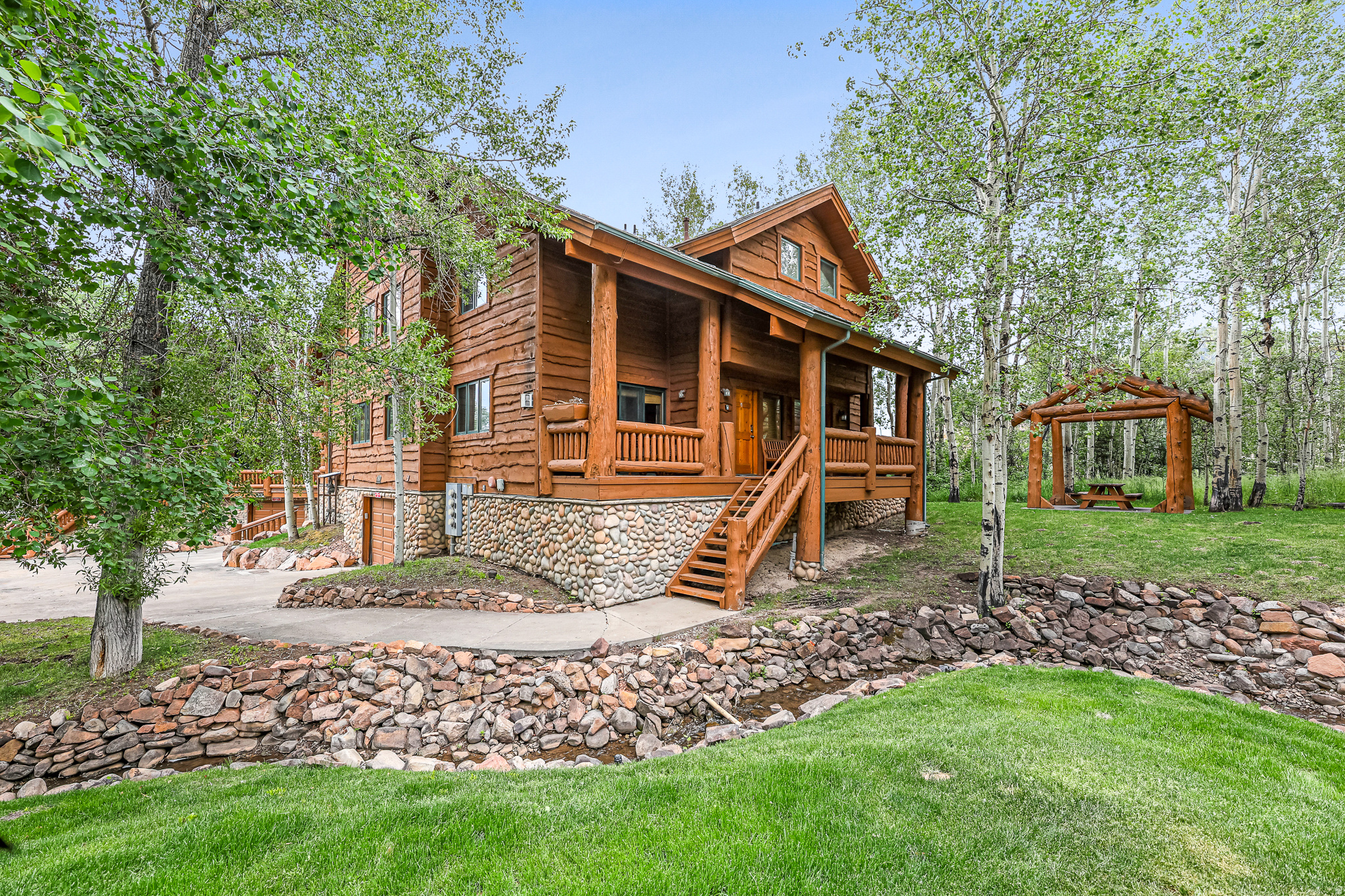 Nestled in the back of Timber Wolf Lodges, this charming mountain condo offers a rare combination of privacy, natural beauty, and convenience. Surrounded by mature trees with a peaceful creek running alongside the property, you'll enjoy the relaxing sounds of nature and the true mountain ambiance that makes Park City so special. Inside, the condo features two spacious primary suites and three bathrooms, providing comfortable accommodations for 10-12 family and guests. A shared garage with space for two small cars or one large SUV adds extra convenience for year-round living or vacation use. Ideally located at the base of Park City Mountain Resort and within walking distance of Canyons Village, this property offers easy access to world-class skiing, hiking, dining, and entertainment. The free Park City transit system is also nearby, making it simple to explore everything the area has to offer. Boasting one of the most desirable locations in Timber Wolf Lodges, this exceptional residence is ideally situated away from highway noise and surrounded by natural beauty. With no adjacent unit on one side, the property enjoys added privacy, expansive green space, and a more secluded mountain feel than many other residences within the community. HOA dues cover utilities, cable, internet, and access to year-round hot tubs, making ownership easy and hassle-free. Nightly rentals are allowed, creating an excellent opportunity for both personal enjoyment and rental income. Whether you're looking for a mountain getaway, a full-time residence, or an investment property, this Timber Wolf Lodges condo offers the perfect blend of location, comfort, and mountain charm. All information is deemed reliable but is not guaranteed and should be independently verified.