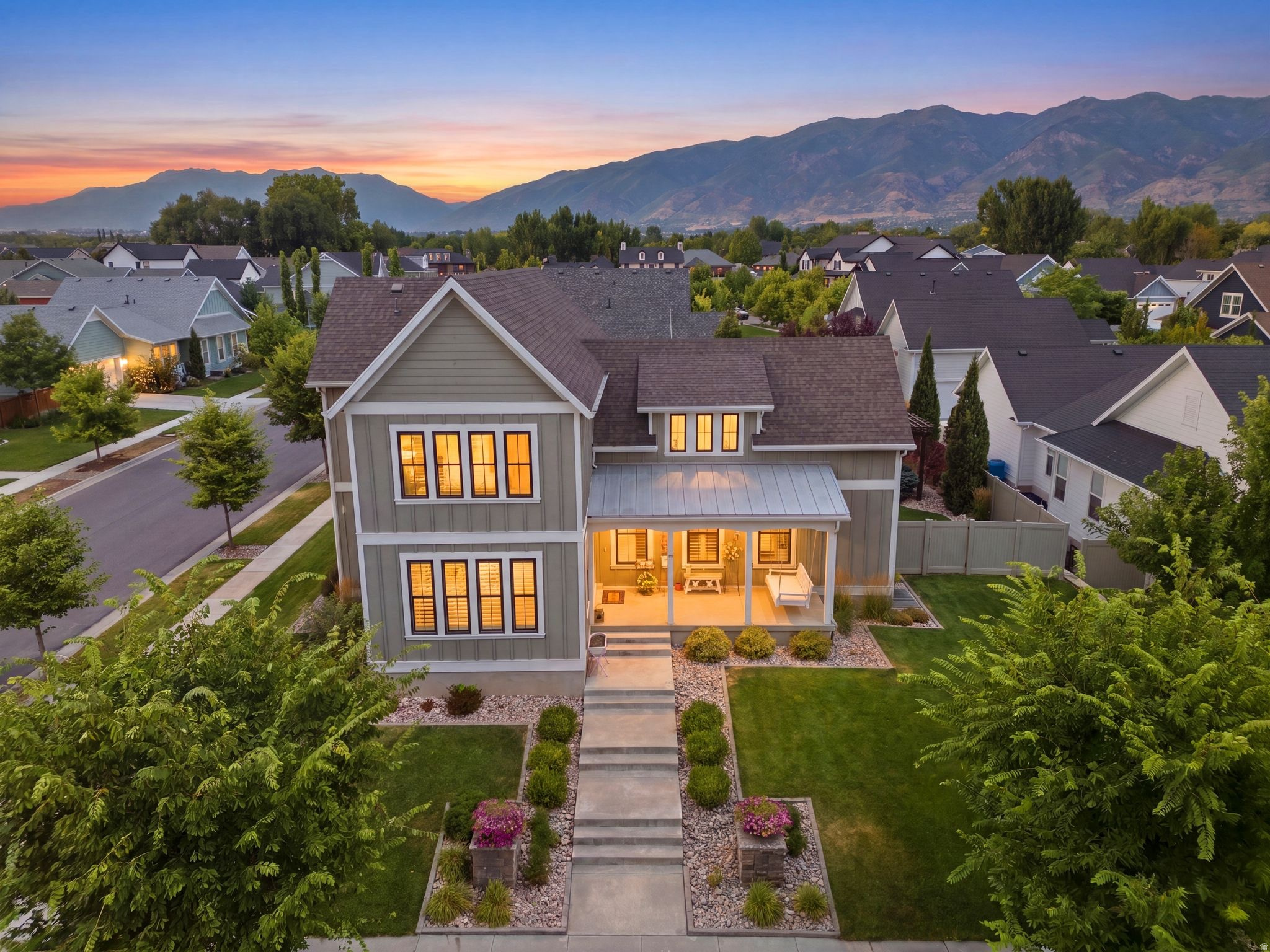 Impeccably designed two-story home in the coveted Hill Farm neighborhood of Kaysville! This immaculate and spacious home welcomes you with soaring ceilings and an abundance of natural light, creating an open, airy feel the moment you walk through the front door. Just off the entry, a spacious office offers the perfect work-from-home space or quiet retreat. A welcoming, spacious front porch with a charming porch swing sets the tone for this exceptional home, while the luxurious main-level primary suite features a private sitting area. Beautiful custom cabinetry and stunning quartz countertops throughout the home showcase the quality craftsmanship and timeless design found in every room. The beautifully appointed kitchen and living spaces are enhanced by custom cabinetry and gorgeous quartz countertops throughout, blending timeless elegance with everyday functionality. The fully finished lower level includes a HIGH QUALITY ADU with its own private entrance, offering the same exceptional finishes as the main level. Complete with a spacious kitchen, dining area, family room, two bedrooms, full laundry, and private access, it's ideal for multi-generational living, guests, or rental income. Step outside to enjoy the beautifully landscaped backyard featuring a large pergola, an expansive patio, and breathtaking mountain views-perfect for entertaining or relaxing. The oversized three-car garage offers extra length and additional width, providing ample space for vehicles, storage, and hobbies. Square footage figures are provided as a courtesy estimate only and were obtained from County Records.  Buyer is advised to obtain an independent measurement.