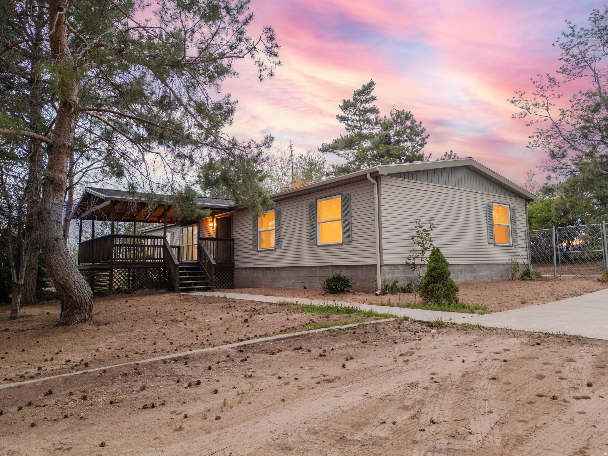 Beautifully renovated & immaculate manufactured home on 3 peaceful acres in Tridell with stunning mountain views and mature shade trees throughout the property. This move-in ready 4 bed, 2 ba home offers comfortable country living with updated finishes, spacious living areas, and inviting covered porches perfect for relaxing and enjoying the scenery. The property is fully fenced and includes valuable BIA water shares, making it ideal for animals, gardening, or hobby farming. A detached 2-car garage provides plenty of storage and workspace. Plenty of room to roam with breathtaking sunsets. Don't Miss! Call Necia today for your showing!