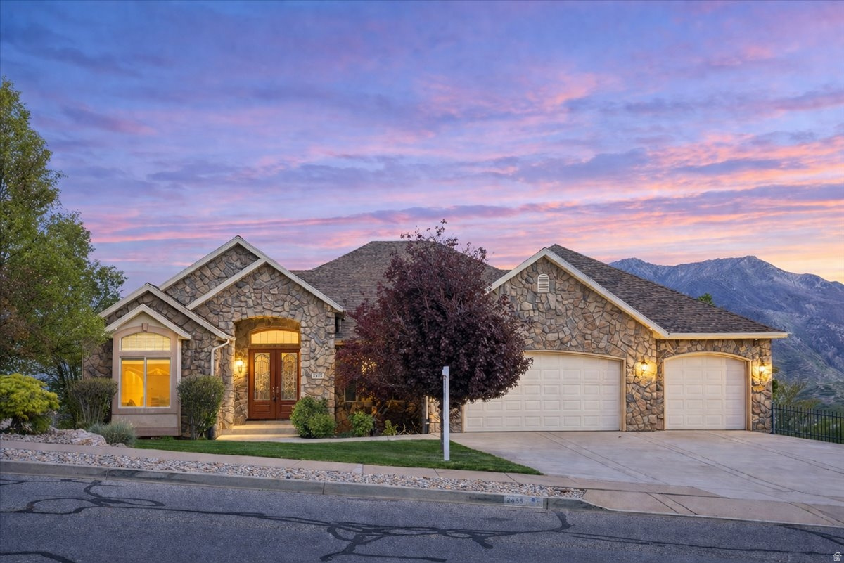 **Price Reduced** Tucked into a peaceful Layton setting, this 6-bedroom, 4-bath home offers 4,960 sq ft of thoughtfully designed living space-blending comfort, functionality, and elevated finishes throughout.  The main level features an open, light-filled layout with a cozy fireplace in the front living room and expansive windows that capture the surrounding views. Just off the kitchen, a private deck creates the perfect space to relax or entertain while taking in the scenery. The kitchen is a true highlight, equipped with a Viking 6-burner cooktop with built-in griddle, pot filler, trash compactor, and ample storage, including unique built-in details.  The primary suite offers a luxurious retreat with heated floors in both the bedroom and bathroom, dual fireplaces with blowers, and a spa-like bathroom featuring a steam shower-designed for both comfort and relaxation.  The fully finished walkout basement adds incredible versatility with a second living space, additional fireplace, basement kitchen area, and direct garage access-ideal for guests, multi-generational living, or flexible use. Abundant storage can be found throughout the home.  Outside, enjoy a serene setting with frequent wildlife, including deer, rabbits, and wild turkeys, creating a peaceful, private feel.  Car enthusiasts and hobbyists will appreciate the rare 7-car garage configuration with garages on multiple levels, offering exceptional space and convenience.  Recent updates include tandem water heaters (2025), professionally cleaned air ducts (2025), heat tape installed on the roof, a newer upstairs furnace, and a water softener (approx. 2016)  Virtually Tour this Home! Ask your agent for the link.