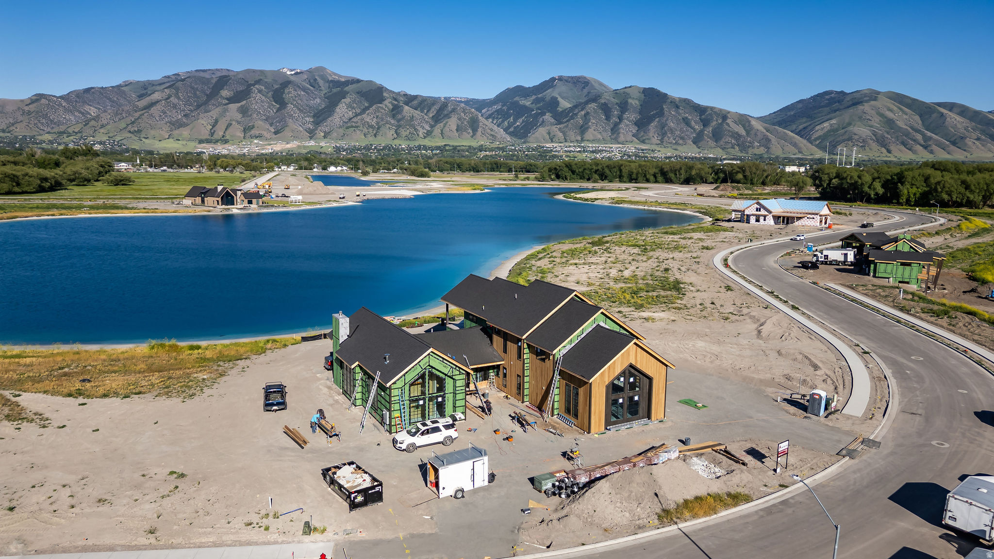 LUXURY BEACHFRONT LIVING IN THE EXCLUSIVE WILLOW LAKES COMMUNITY! This stunning lakefront retreat showcases elevated mountain-modern design with expansive windows, premium finishes, and breathtaking panoramic views of the Surf Lake and the Bear River Range. The oversized second-story viewing deck creates the perfect setting to take in Cache Valley's incredible sunsets and waterfront scenery.  Thoughtfully designed for both entertaining and relaxation, the home features a real cedar exterior, spacious bedrooms with private ensuite bathrooms, a dedicated bunkroom, and seamless indoor-outdoor living with a white sandy beach just steps from the back deck.  Enjoy full access to the unmatched Willow Lakes lifestyle, including private beaches, trails, Logan River access, pickleball courts, pool and hot tubs, and a spectacular 30,000 sq. ft. clubhouse and fitness center complete with spa-style amenities.  Recently recognized by World Atlas as one of the Top 10 Resort Towns in the USA, Logan offers year-round recreation, natural beauty, and an exceptional mountain-lake lifestyle unlike anywhere else. Call today for a private showing or to receive a copy of a virtual video tour.