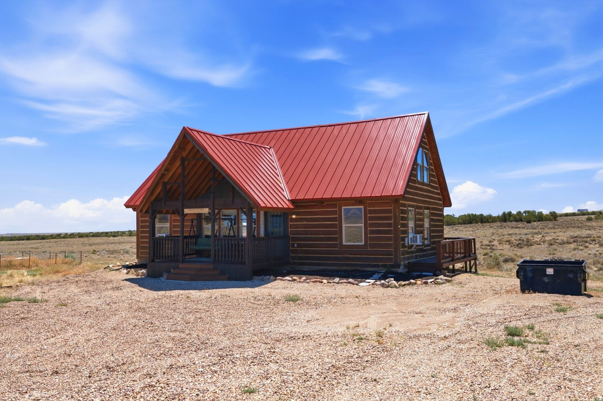 Year-round accessible eastern Utah cabin on 2.51 acres in the Utah Mini Ranches community near Duchesne. The home offers 1,565 square feet of living space with 2 bedrooms, 2 full bathrooms, and 2 loft and bonus spaces well suited for additional sleeping quarters, guests, office space, or gear storage. A durable metal roof and included kitchen appliances + washer and dryer.  2026 improvements include a wraparound deck, refreshed carpeting, freshly stained and clear-coated exterior wood surfaces, painted deck and porch.  Located approximately 7 minutes from downtown Duchesne City, 10 minutes from Strawberry River, 20 minutes from Starvation Reservoir, and within easy reach of Ashley National Forest, ATV trails, hunting, fishing, boating, and endless recreation opportunities.  A-2.5 zoning supports the flexibility associated with rural living and recreational use, subject to county regulations and HOA guidelines.  The $80/month HOA includes culinary water service, private road maintenance, snow removal, and common area maintenance.
