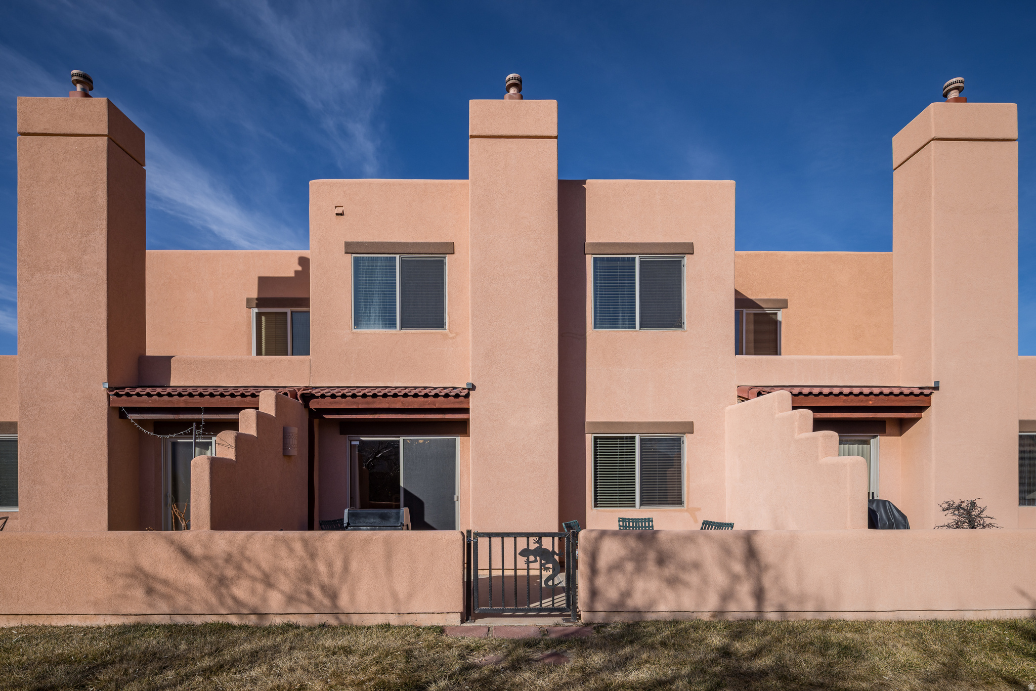 AMAZING SETTING - Next to Moab's Golf Club, this delightfully maintained Castillo de las Rocas unit is completely turn-key ready for you! The main level has beautiful Saltillo tile throughout the entry and kitchen alongside the cozy living room with gas fireplace. Exceptional outdoor space off the dining room adjacent to hole 13 for you to soak in the phenomenal Moab Rim views. This level also has a one car garage and full bathroom. The upper level offers 2 bedrooms, bonus flex-room, a full bathroom, and gracious closets. Enjoy living next to the sunny community pool within walking distance to upper Mill Creek hiking trails and world class 4x4 trailhead access. Located in the Overnight Lodging Overlay, this bright home has established rental history and is ready to be your vacation rental, second home, or your primary residence!