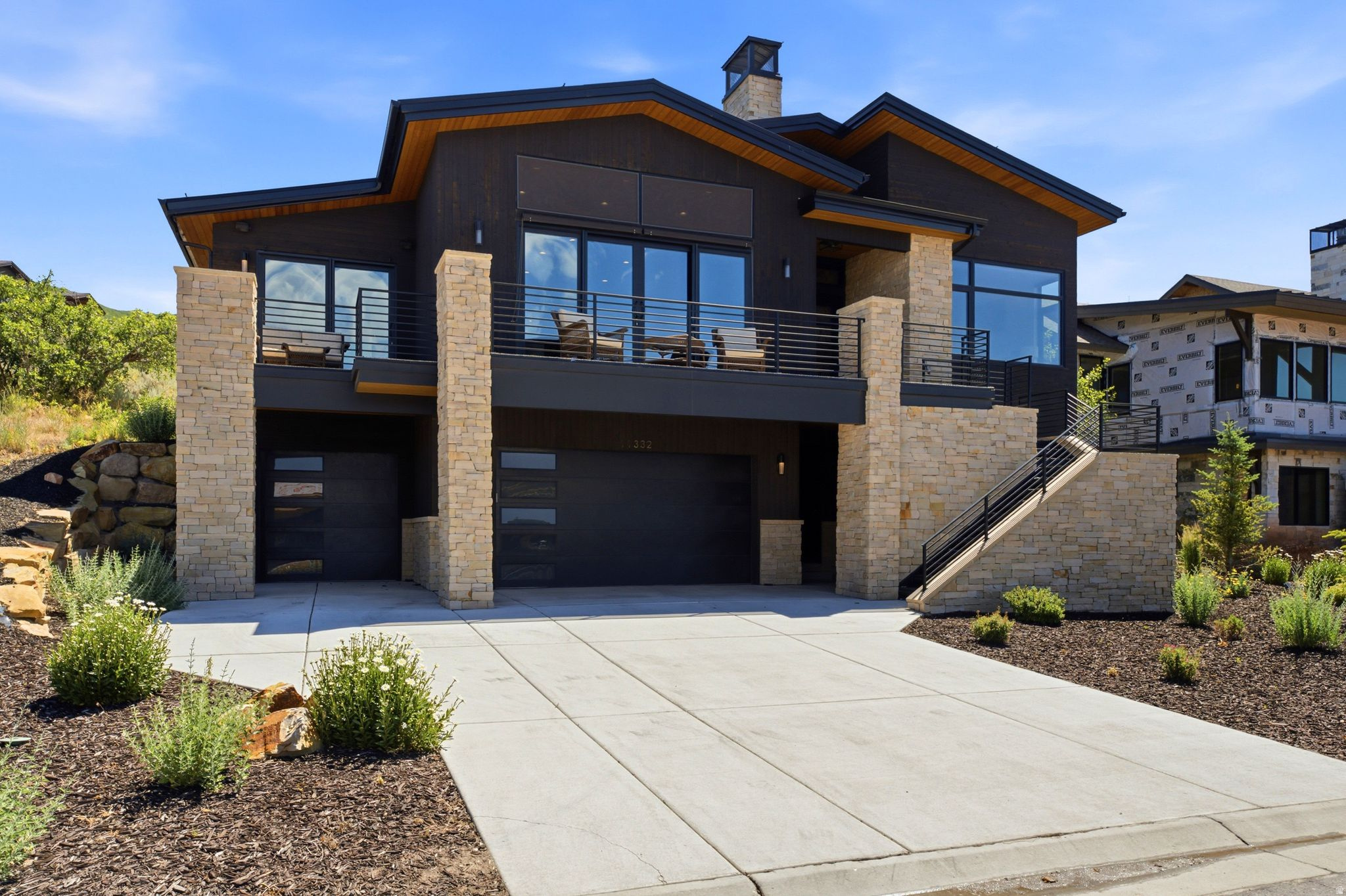 Enter this exquisite 4-bedroom, 3.5-bath recently constructed residence and be immediately captivated by stunning views of Deer Valley's ski runs and a serene lake, perfectly framed by the expansive living room windows and doors seamlessly flowing between the beautiful outdoors and the elegant interior, enhancing the 3,355 sq ft of living space that defines this luxury mountain home.  The kitchen is a chef's delight, centered around a 20 foot island, marrying functionality with grandeur. The main level's open layout ensures that cooking and entertaining are a visual and experiential pleasure, complemented by the panoramic scenery.  The master suite offers a tranquil retreat, featuring a spa-like bathroom and extensive closet space for ultimate comfort and privacy. The additional bedrooms are thoughtfully designed, ensuring that each provides comfort and elegance.  The lower level has a spacious 3 car garage and 2 spacious bedrooms with a large bathroom between them.  Step outside onto the expansive private patio space!  The front deck takes the spectacular sunsets over the mountains and lake, an idyllic backdrop for both lively entertainment and tranquil contemplation.  Located just 18 minutes from the new Deer Valley East Village, this home offers convenient access to world-class skiing, boating, and hiking, placing outdoor adventures right at your doorstep.  11332 White Tail Court is more than a residence-it's a gateway to a lifestyle of luxury, adventure, and scenic beauty, waiting to be called home.