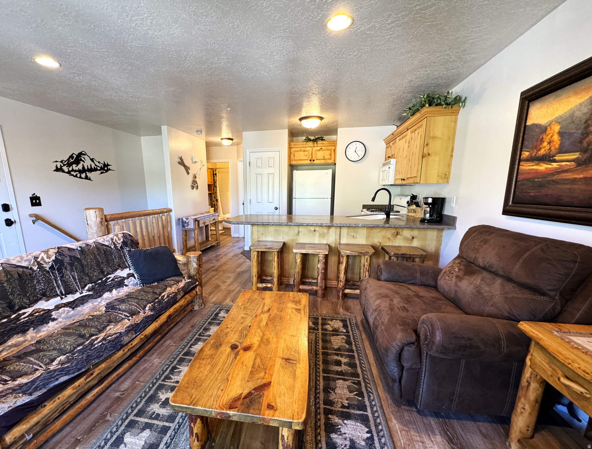 Spacious 4-bedroom 3-bath mountain retreat located in the highly desirable Moose Hollow Condominiums. Situated in Ogden Valley this unit provides access to year round recreation including world-class skiing at Snowbasin, Powder Mountain and Nordic Valley, championship golf at Wolf Creek Golf Course, as well as boating, paddleboarding, hiking, mountain biking and beaches around Pineview Reservoir. The open concept living area has a large bar and gas fireplace in the cozy family room with ample natural light and a deck with mountain views. The condo is turn-key ready with a well stocked kitchen, pantry, cabinetry, and decorations. The spacious primary suite has a new king sized mattress. Two private rooms each have a queen sized bed. The bonus 4th bedroom has 2 queens. The unit comfortably sleeps up to 10 people making this a highly desirable rental option. Additionally, there is a laundry room, storage closets inside and out in the main area. The facilities include a seasonal pool, a year-round hot tub right out your back door, sauna, fitness center, recreation room in the clubhouse and a sand volleyball court. The HOA manages all exterior maintenance, facilities, snow removal, internet, cable, garbage, water, sewer and landscaping. This is an exceptional vacation get-away, primary residence or turn key short and long term rental. Do not miss out on this one, contact the agent today. All information is provided by sellers to the best of their knowledge, buyer to verify.