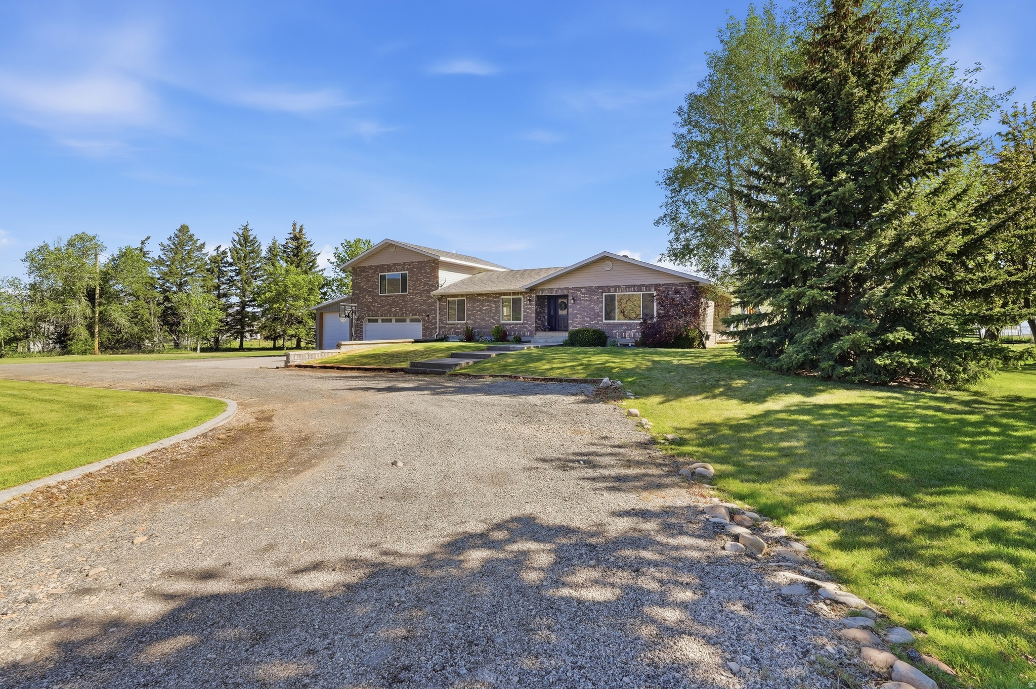 Escape to the ultimate country lifestyle without sacrificing convenience. Situated on 2.02 acres zoned for livestock, this rare Heber property is a dream come true for homesteaders, hobby farmers, and outdoor enthusiasts. This home offers over 5000 square feet of spacious living, with 5 bedrooms, 4 bathrooms plus a bonus exercise or office space. The home has been beautifully maintained and updated with a gourmet kitchen, HVAC and windows within the last 5 years. Adding incredible versatility is the fully finished basement, which has a private 1-bedroom apartment with its own entrance, perfect for guests, multi-generational living, or rental income. The property boasts a massive 12' x 32' RV garage, a 12' x 20' shop area, and a colossal 40' x 72' greenhouse that allows you to grow your own organic produce year-round. 3 shares of water are included. Whether you want to raise animals, cultivate a massive garden, or work on projects in your private shop, this estate offers the space and freedom to do it all. Conveniently located minutes to shopping, restaurants, schools, world class ski resorts and all the amenities needed, you'll love the lifestyle this property provides. Buyer and Buyer agent to verify all.