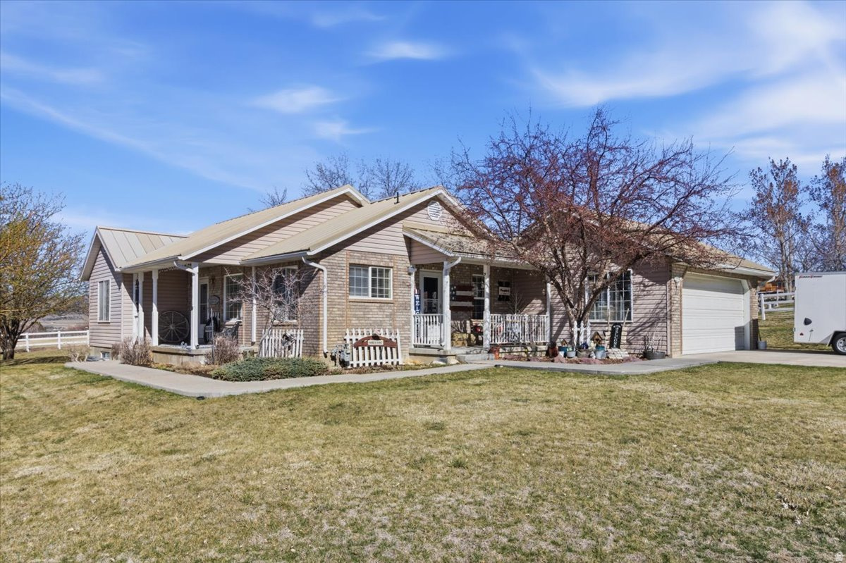 This beautifully maintained 4-bedroom, 3-bath home sits on just over an acre, offering comfort, space, and rural charm. Enjoy your own mature fruit trees, a thriving vegetable garden, and the added value of two water shares. Inside, you will find a renovated kitchen with new appliances, updated flooring, fresh paint, and an energy-efficient furnace. A durable metal roof adds long-term peace of mind. Meticulously cared for by its owners, this home is move-in ready and perfectly suited for enjoying country living.
