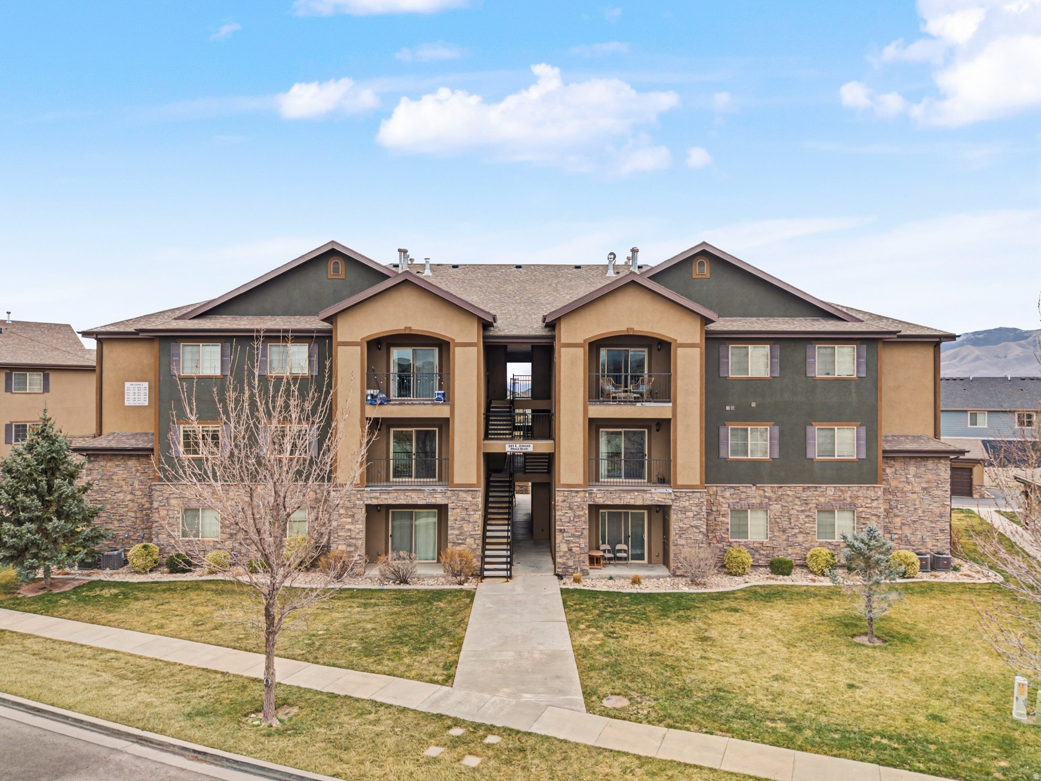 Welcome to this adorable condo in Saratoga Springs! Situated one level above the main floor, offering privacy and security along with a balcony view perfect for relaxing outdoors. This well-maintained and updated unit has a spacious, functional layout offering 3 bedrooms and 2 renovated bathrooms along with a 2-car garage with overhead storage! This condo provides flexibility for families, guests, or a home office.  interior features include a bright, beautiful kitchen with white cabinetry and light granite countertops.   Both bathrooms updated with new vanities, new quartz countertops with under-mount sinks, new toilets, new faucets, & new LVP flooring. The unit has also been freshly painted in the last year and updated light fixtures.  You will appreciate the spacious laundry room - washer and dryer included! Enjoy the surrounding community amenities, including a patio area and gazebo, ideal for families with children or couples looking to unwind and enjoy the outdoors.  Additonal parking on Jordan Ridge Blvd provides plenty of guest parking in addition to parking within the community. This community is very quiet yet ideally located close to shopping, parks, and the Jordan River Trail system. Clean, inviting, and move-in ready, this charming condo is one you won't want to miss.