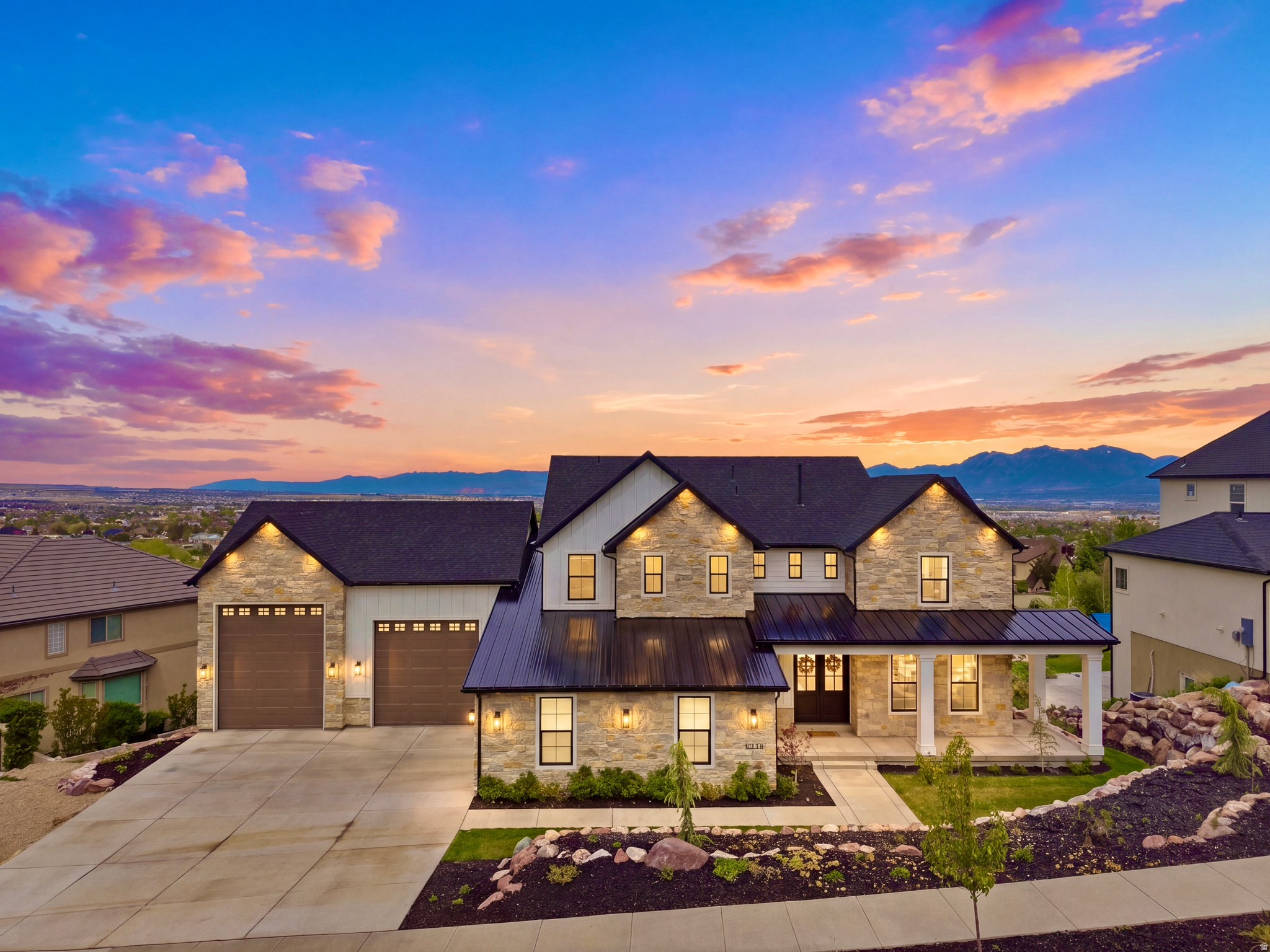 $105,000 PRICE REDUCTION!!!  Perched high against the mountainside in Herriman, this newly completed CUSTOM LUXURY ESTATE offers BREATHTAKING PANORAMIC VALLEY VIEWS, extraordinary privacy, and over 10,000 square feet of thoughtfully designed living space with NO HOA. Completed in 2025, the home blends elevated design with exceptional functionality, featuring HIGH END FINISHES throughout including quartzite, quartz, granite, porcelain surfaces, custom stonework inspired by Studio McGee, expansive Pella windows, and carefully curated luxury details at every turn.  Designed for both everyday comfort and unforgettable entertaining, the home features a STUNNING CHEF'S KITCHEN with Sub Zero refrigeration, built in pebble ice maker, and a separate BUTLER'S KITCHEN for seamless hosting. A FULL MOTHER-IN-LAW KITCHEN downstairs creates ideal flexibility for multi generation living, long term guests, or private entertaining spaces.  The home was intentionally built for comfort, privacy, and performance, including MULTI ZONE HVAC, upgraded sound insulation throughout, generator and solar pre wiring, electric blinds, EV CHARGING capability, and extensive SMART HOME infrastructure already in place.  Standout spaces include a DEDICATED THEATER ROOM featuring a professionally installed $50,000 HOME THEATER SYSTEM with immersive surround sound, premium projection, custom acoustic treatments, and elevated cinematic seating designed to deliver a true luxury movie experience from the comfort of home. Additional highlights include an extraordinary HIDDEN VAULT DOOR SECRET ROOM, multiple laundry rooms for convenience on every level, and a rare SUB BASEMENT GARAGE ideal for recreational vehicles, storage, or hobbies.  Outdoor living is equally impressive, with a gas firepit, breathtaking mountain and valley views, and a backyard already prepared for a FUTURE POOL INSTALLATION. With a 5-CAR OVERSIZED GARAGE, exceptional craftsmanship throughout, and a location consistently ranked among Utah's most desirable communities, this is a rare opportunity to own a TRULY ONE OF A KIND CUSTOM ESTATE designed for MODERN LUXURY LIVING.