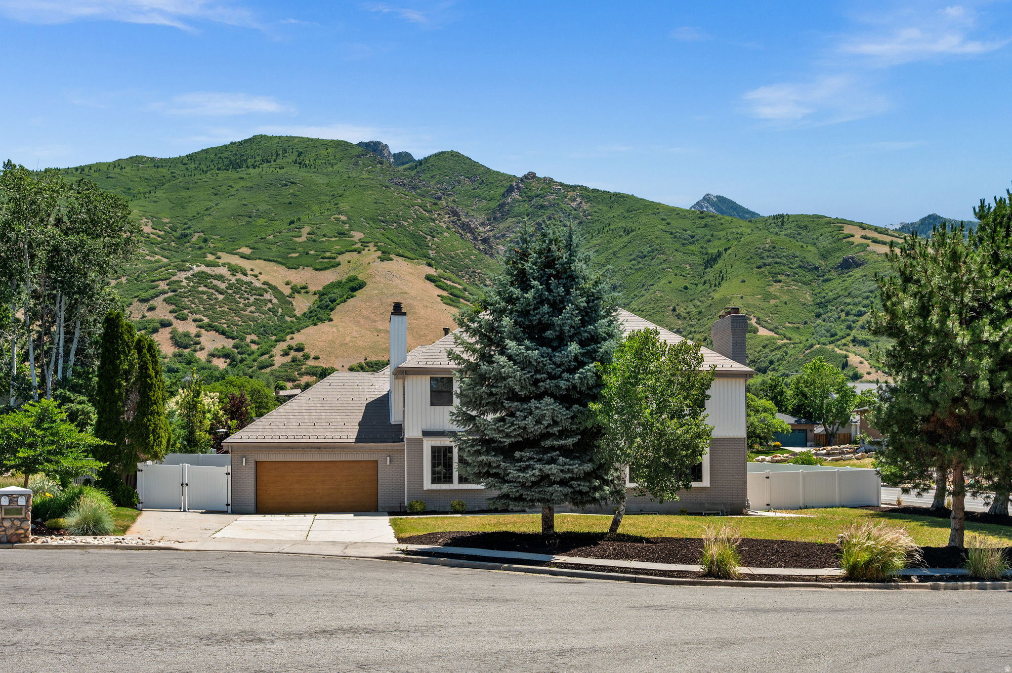 Situated in one of the most sought-after locations along the Wasatch Front, just below Wasatch Boulevard and perfectly positioned between Big and Little Cottonwood Canyons, this exceptional home offers the ideal blend of comfort, space and outdoor accessibility. The heart of the home is a beautifully appointed kitchen featuring an oversized island with abundant workspace and seamless flow into the spacious family room and formal dining room-creating the perfect setting for entertaining, everyday living, and easy access to the outdoor living spaces. Upstairs, you'll find four  bedrooms, including a stunning primary suite with soaring vaulted ceilings, a fireplace, a spa-inspired bathroom with a soaking tub and glass-enclosed shower, and a large walk-in closet. A rare top-floor bonus room provides nearly 500 square feet of additional living space, ideal for a game room, media room, or retreat. The lower level offers incredible versatility with a fifth bedroom,  bathroom, large family room, and a secondary kitchen-perfect for guests, multi-generational living, or entertaining. Ample storage can be found throughout the home.The house has an attached two car garage and an additional parking slip for an RV. Outside, enjoy spectacular views of the Wasatch Mountains and take advantage of a location that puts world-class skiing, hiking, and recreation at your doorstep. Big and Little Cottonwood Canyons are just minutes away, Bell Canyon and Ferguson Canyon are nearby, and Salt Lake City International Airport is approximately 20 minutes from home. Grocery stores, restaurants, shopping, and everyday conveniences are all within a mile, making this an unbeatable combination of lifestyle, location, and livability.