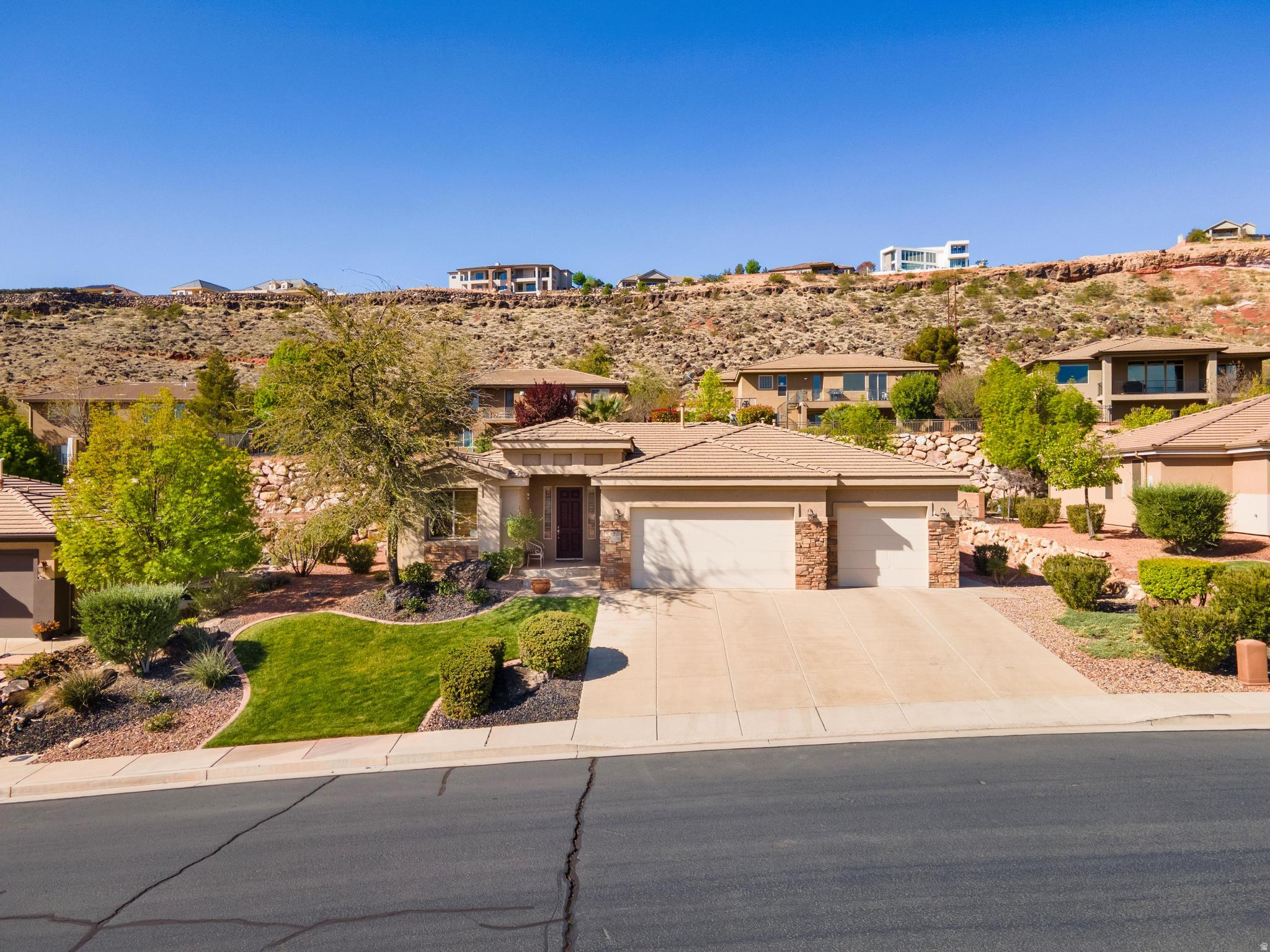 This beautifully maintained home in the desirable Primrose Point subdivision, located directly across the street from the scenic Virgin River Trail, offering easy access to walking, biking, and outdoor enjoyment right from your front door. A furniture package is available for buyers looking for a turnkey option. This 3 bedroom/office move-in ready home has been lightly lived in and shows pride of ownership throughout, situated in a quiet, well-kept neighborhood. Inside, you'll find a bright and inviting layout with updated paint, newer carpet and padding, upgraded light fixtures, ceiling fans, woven wood blinds, and plantation shutters that add warmth and style throughout the home. The entry features an elegant coffered ceiling, and the spacious living areas feel open and comfortable. The kitchen offers granite countertops, KitchenAid gas range/oven, GE microwave, dishwasher, updated disposal and brand-new Bosch refrigerator, and abundant cabinet space, along with a laundry room sink and additional storage cabinets for convenience. The refrigerator, washer, dryer and patio set are included, making this home truly move-in ready. The primary suite features dual vanities, a soaking tub, and a walk-in shower and roomy walk-in closet, creating a relaxing retreat. Additional updates include some newer windows, updated faucets, and a newer patio perfect for outdoor living. The yard is fully fenced and beautifully landscaped with roses, and mature wisteria shrubs, creating a peaceful outdoor setting. The home has never had pets or smoking and has been exceptionally cared for. Enjoy the perfect combination of location, condition, and comfort in this lovely Primrose Point home, just steps from the Virgin River Trail.