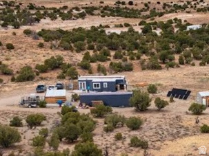 Motivated Seller!  This is a Double Container Home on 40.54 acres southeast of Duchesne! It is only 2 years old! Completely off grid!  It Includes a septic system, solar power, and generator back up! Mini splits provide heating and cooling comfort year 'round!  It includes an 1100 gallon water cistern. Water delivery service is available, or you can bring in your own. 1 bedroom, 1 bath. Open Living room/Kitchen/Dining. There is a built on area for storage, studio, shop, or whatever your needs are! The Connex container is  40 feet long, 8 feet wide, 9 feet high, and is included! It provides great storage, and possibly a great garage! This home meets ADA requirements with a handicap ramp, and accessible placements of appliances and fixtures. A barrier free, continuous access is throughout the home for individuals with mobility limitations.  This home qualifies for a loan.  Ask us!