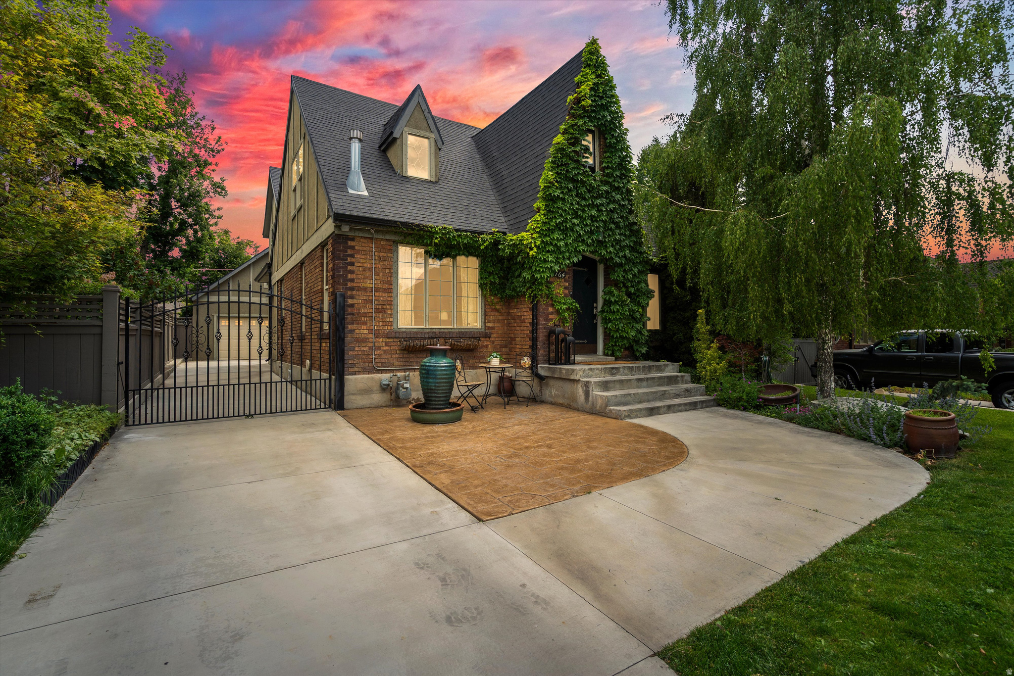 Located on one of the most coveted blocks in Upper Yalecrest, 1764 Herbert Avenue presents a truly exceptional opportunity. Blending timeless 1920s English Tudor character with an expansive 4,041-square-foot footprint, this classic residence offers the perfect canvas for inspired custom design. Steeped in architectural integrity, the home showcases a striking historic silhouette, rich wood floors on the main level, and beautiful woodwork throughout. The main floor flows effortlessly from living spaces to a warm and inviting study, opening into a light-filled kitchen and dining area designed for both everyday living and entertaining. The spacious primary ensuite serves as a private retreat, featuring vaulted ceilings, a large walk-in closet, and direct access to a secluded patio. The lower level offers remarkable flexibility with 9-foot ceilings, an additional bedroom and three-quarter bath, a generous family room, and a versatile bonus space. Outside, the grounds transform into a peaceful sanctuary with a charming patio and sitting area replete with a tranquil water feature-an idyllic escape from the pace of the valley. A spacious detached two-car garage provides a rare neighborhood advantage and includes unfinished space above, ready to be transformed into a studio, office, guest suite, or creative retreat. Establish your legacy in one of Salt Lake City's premier historic neighborhoods, where timeless character meets exceptional potential. Ideally located within walking distance of local parks, Emigration Market, and beloved neighborhood cafs.   Square footage figures are provided as a courtesy estimate only and were obtained from county records.  Buyer is advised to obtain an independent measurement.