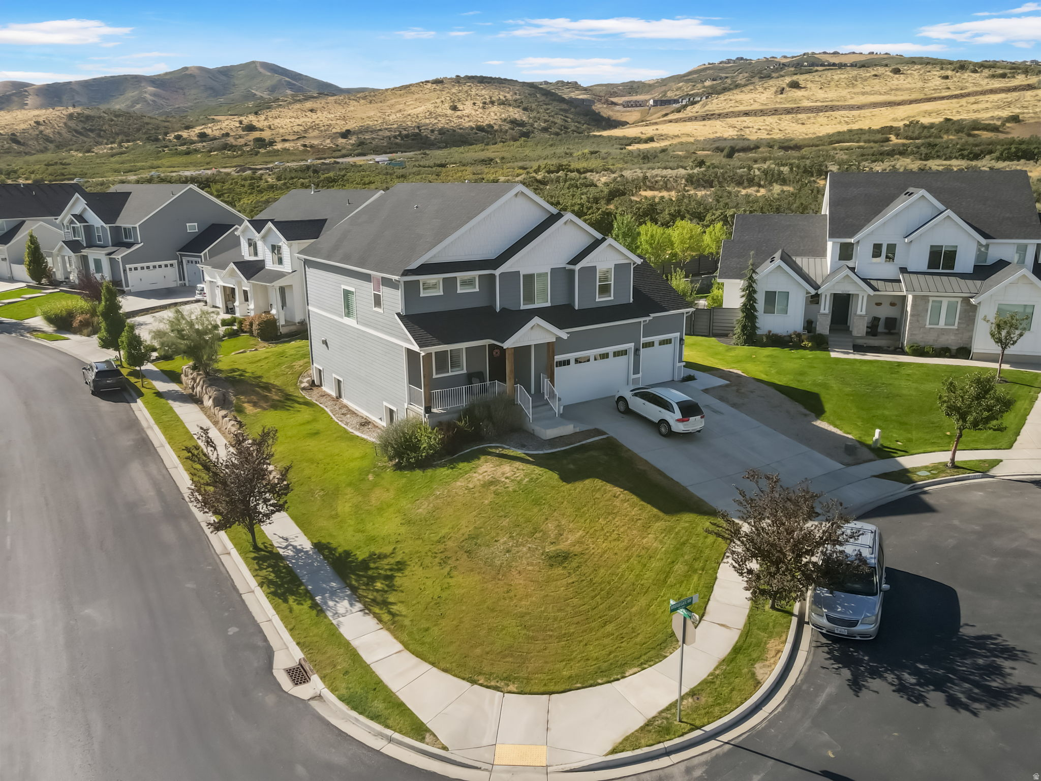 *Price Improvement / Seller financing available * Situated on a premium corner lot in a quiet cul-de-sac within the award-winning Skye Estates community, this stunning Craftsman-style home showcases sweeping mountain and valley views in a truly sought-after setting. The thoughtfully designed open-concept floor plan is filled with natural light and anchored by a gourmet kitchen featuring 3 cm quartz countertops, double ovens, custom cabinetry with a wood hood, and an impressive 8' x 8' sliding glass door that seamlessly connects indoor and outdoor living. Eight-foot doors throughout the main level and a dining room with a two-foot cantilever enhance the sense of space and architectural interest. The primary suite is a true retreat, offering a spa-inspired bathroom with an elongated soaking tub, ornate tile shower surround, and Euro glass enclosure. Adding exceptional versatility, the fully finished basement includes a separate private entrance located behind the third-car garage and functions as a complete apartment. It offers a full kitchen, spacious bedroom, full bathroom, washer and dryer, and direct access to a private movie theater room, ideal for rental income or multi-generational living. Built with 2" x 6" exterior walls and a 96% efficient furnace, the home delivers comfort, durability, and energy efficiency. Combining luxury finishes, functional design, and an unbeatable location, this home presents a rare opportunity to own in one of the area's most desirable communities.  Square footage figures are provided as a courtesy estimate only and were obtained from County Records.  Buyer is advised to obtain an independent measurement.