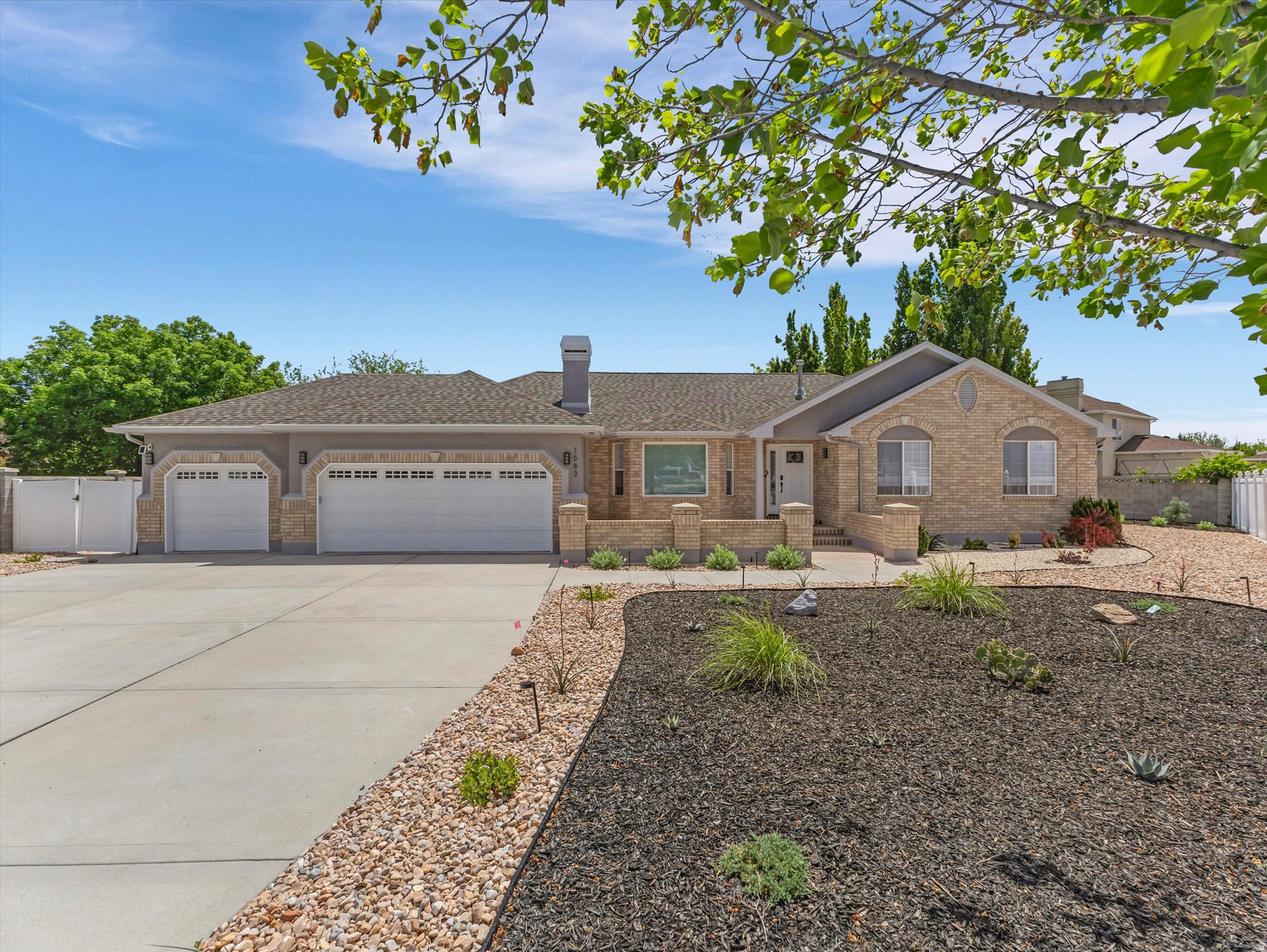 Beautifully and thoughtfully remodeled South Jordan rambler in a quiet cul-de-sac in close proximity to I-15 and Brigadoon Park. The closer you look, the more impressed you will become with the upgrades to this practical and livable home. The kitchen, bathrooms, and laundry room renovations modernize the bright and open architecture. The new gourmet kitchen is equipped with white cabinetry, an extensive wall pantry featuring soft-close doors and pull-out shelves, upgraded granite countertops, a backsplash, and a large center island. The kitchen also boasts Samsung Bespoke appliances (refrigerator, range, and dishwasher), a wood-clad range hood, a new faucet, and a reverse osmosis water system. The functional open-concept great room, dining area, and kitchen feature vaulted ceilings and a welcoming, free-flowing atmosphere, making this the heart of the home. From the dining area, you can step out through a new sliding door onto the patio. In the great room, you will appreciate the gas fireplace with a marble surround, a wall-mounted television, large sunny windows, and new modern lighting. Significant recent upgrades include new wide-plank LVP flooring on the main floor, LED lighting throughout the upstairs, soundproof European-style doors, full interior and exterior paint, modern baseboards, sleek air registers, custom Levolor blinds, a contemporary stair railing, modern acoustic wall accents, and designer sliding closet doors in two bedrooms. The updated bathrooms include newer tile, showers/tubs, toilets, mirrors, fans, and lighting. The primary suite features designer sliding doors to the walk-in closet and bath, LED ceiling and pendant lighting, a motorized Levolor blind, a decorative accent wall, and a mounted TV with soundbar. The spa-like primary bath is finished with a double vanity, Euro glass shower, and freestanding soaking tub. The reimagined main-level laundry room includes an acoustic wall accent, mudroom cabinet, newer Samsung Bespoke stacked washer and dryer, and a luxurious custom dog wash. The lower level features a spacious family room with a gas fireplace accented by a marble surround, an extensive wall of custom bookcases, LED lighting, and two barn doors for privacy separation. Also included are two large bedrooms with ample closet space, storage adjacent to the utility room, a large cold storage room, and roughed-in carpentry for future expansion. The three-car garage features epoxy flooring, new high-wall garage door mounts and openers, an EV charger, a wall-mounted electric heater, sprinkler controller, mounted motorized TV, and additional attic insulation. Also included are a Ring doorbell and three solar security cameras. Rest easy knowing there is newer porch and garage outdoor lighting, a roof installed in 2015, a furnace and AC from 2019, a high-efficiency tankless water heater installed in 2026, and a radon mitigation system added in 2026. The home has been meticulously maintained, and the following items were serviced in 2026: the reverse osmosis water system, water softener, both gas fireplaces, and the furnace. Did we mention the complete re-piping of the home's water system with PEX piping, a main water shut-off valve, pressure regulator, shower valves, and frost-free exterior hose bibs in 2026? With consideration for long-term outdoor watering concerns, you will love the complete 2025 re-landscaping, including artistically crafted xeriscaping, solar lighting, and drip-watered, drought-tolerant flora. The highlight is the Italian porcelain tile walkway leading to the cozy fire pit area. South Jordan secondary water is also available on the property. Considering its location, functionality, and open feel, this is a home you will not want to miss, especially with the extensive list of recent upgrades providing both peace of mind and elegant beauty. Buyer to verify all info and dimensions.