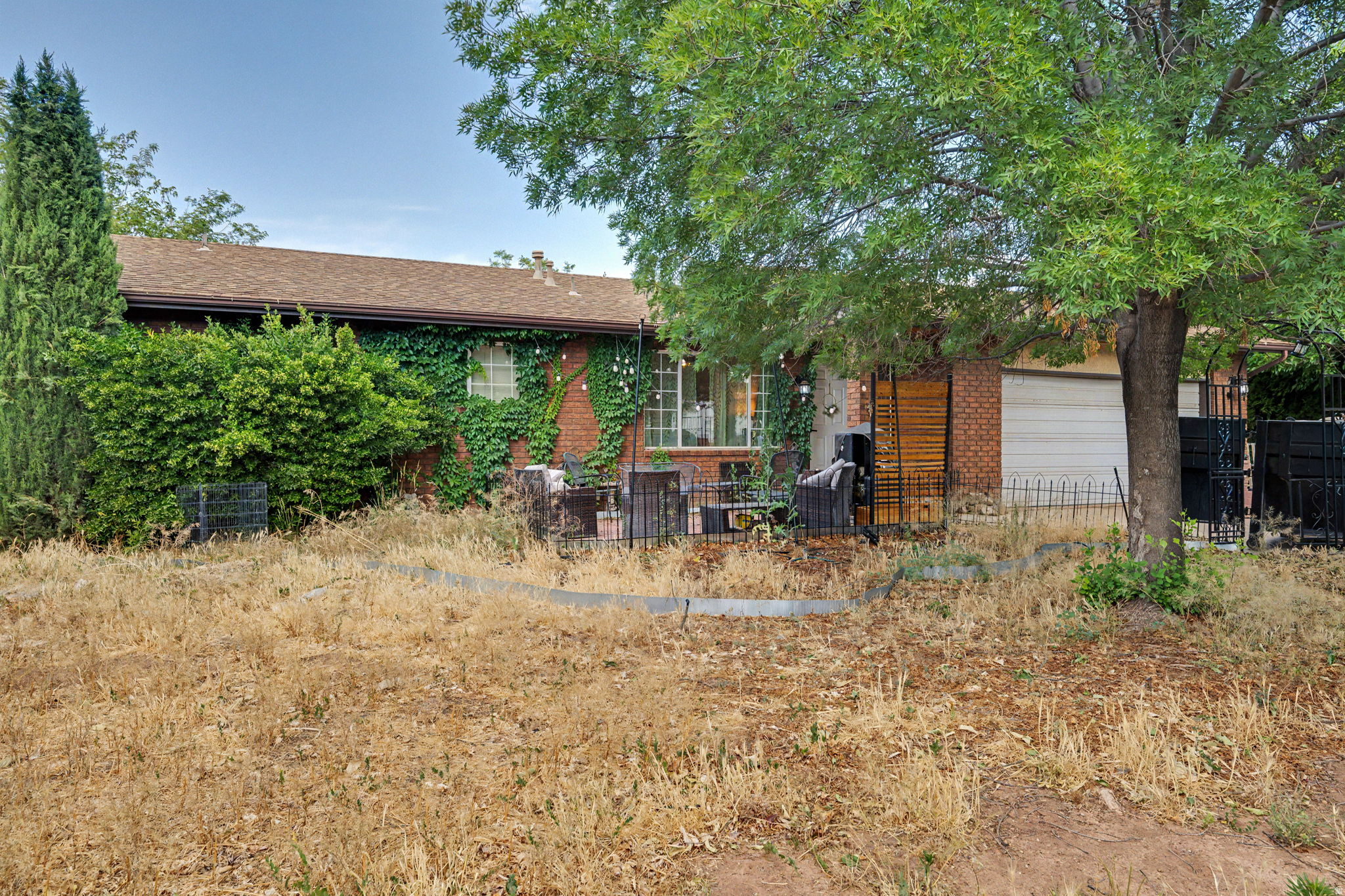Single-family home in a quiet La Verkin neighborhood with no HOA and plenty of potential. The charming front patio is framed by mature ivy, lush trees, and string lights -- a welcoming outdoor space perfect for relaxing or entertaining. The home features a functional layout with a kitchen island, ceiling fans throughout, and a garage. The spacious backyard offers mature trees, room to landscape, and a canvas ready for your personal touch. Located just minutes from Hurricane, Zion National Park, and easy access to St. George. This is a great opportunity to own in a convenient Southern Utah location at an accessible price point.