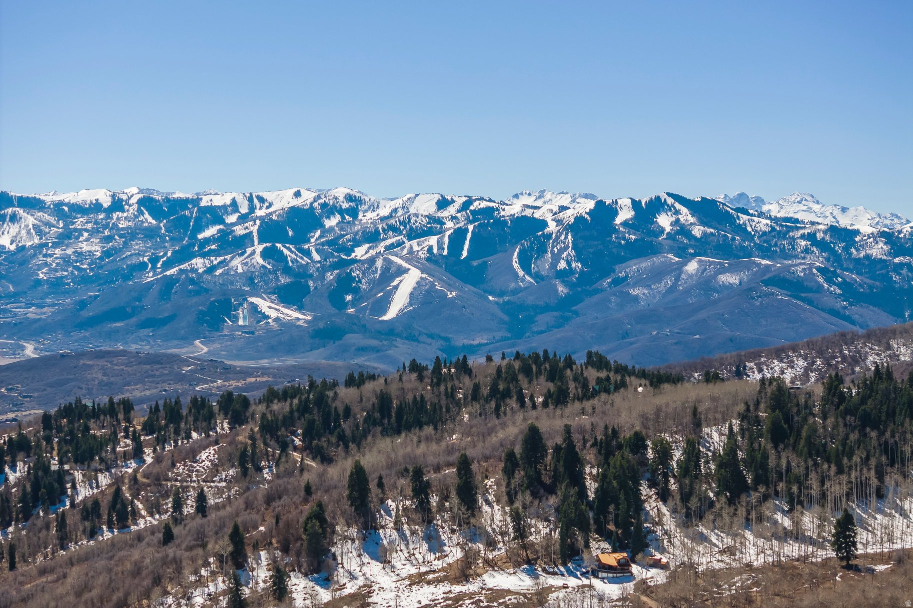 Experience one of the most remarkable view properties in the Park City area within the private, gated community of Stagecoach Estates, just minutes from town. This homesite offers truly extraordinary 270 degree panoramic views that stretch across the Uintah Mountains and extend all the way to Mt Superior in Little Cottonwood Canyon, creating a setting that is nearly impossible to replicate and rivaling anything else you will find in Park City. The building area features a gentle slope that is well suited for a thoughtfully designed mountain home, perfectly oriented to capture the surrounding landscape from every angle. Mature evergreens add character and a sense of privacy while enhancing the natural alpine setting. With a generous building envelope and exceptional design potential, this property presents a rare opportunity to create a legacy mountain retreat. Located within the highly sought after Park City School District and offering low annual HOA dues, it delivers an ideal balance of close proximity to town and the ultimate in privacy.