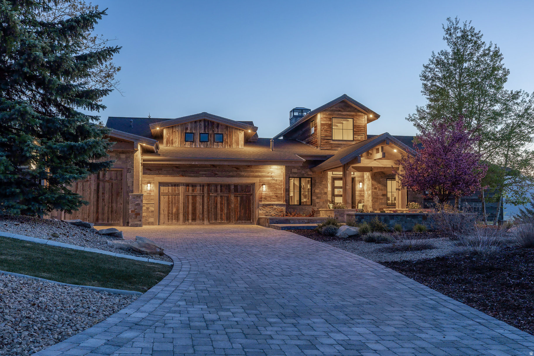 Framed by panoramic mountain views with direct access to Round Valley's open space, this custom retreat in the Trailside neighborhood blends striking architecture with effortless comfort. Designed by Jean-Yves Lacroix and built by Big Canyon Homes, natural elements of reclaimed wood, stone and metal echo the scenic mountain landscape. Walls of glass dissolve the boundary between inside and out, opening to terraces, fire lit gathering spaces, and private mountain vistas. A grand entry opens to a stone fireplace and inviting living area and spacious gourmet kitchen, with an office, guest suite, primary suite, and indoor sport court on the main level providing seamless access to a wonderful gathering area with a large fire pit framed by panoramic mountain views. A second entertainment room with a wet bar, full gym with steam shower, and three additional ensuite bedrooms on the lower level complete this coveted floor plan, while an oversized mud room and heated three-car garage with a dog wash and room for a Sprinter van and all the gear complements four seasons of active mountain living. Steps from trails and schools and minutes from skiing and Main Street, this home captures the heart of mountain living- where sunrise hikes, aprs ski by the fire and moments shared under star-filled skies become daily rituals. It's more than a home-it's your family's legacy.