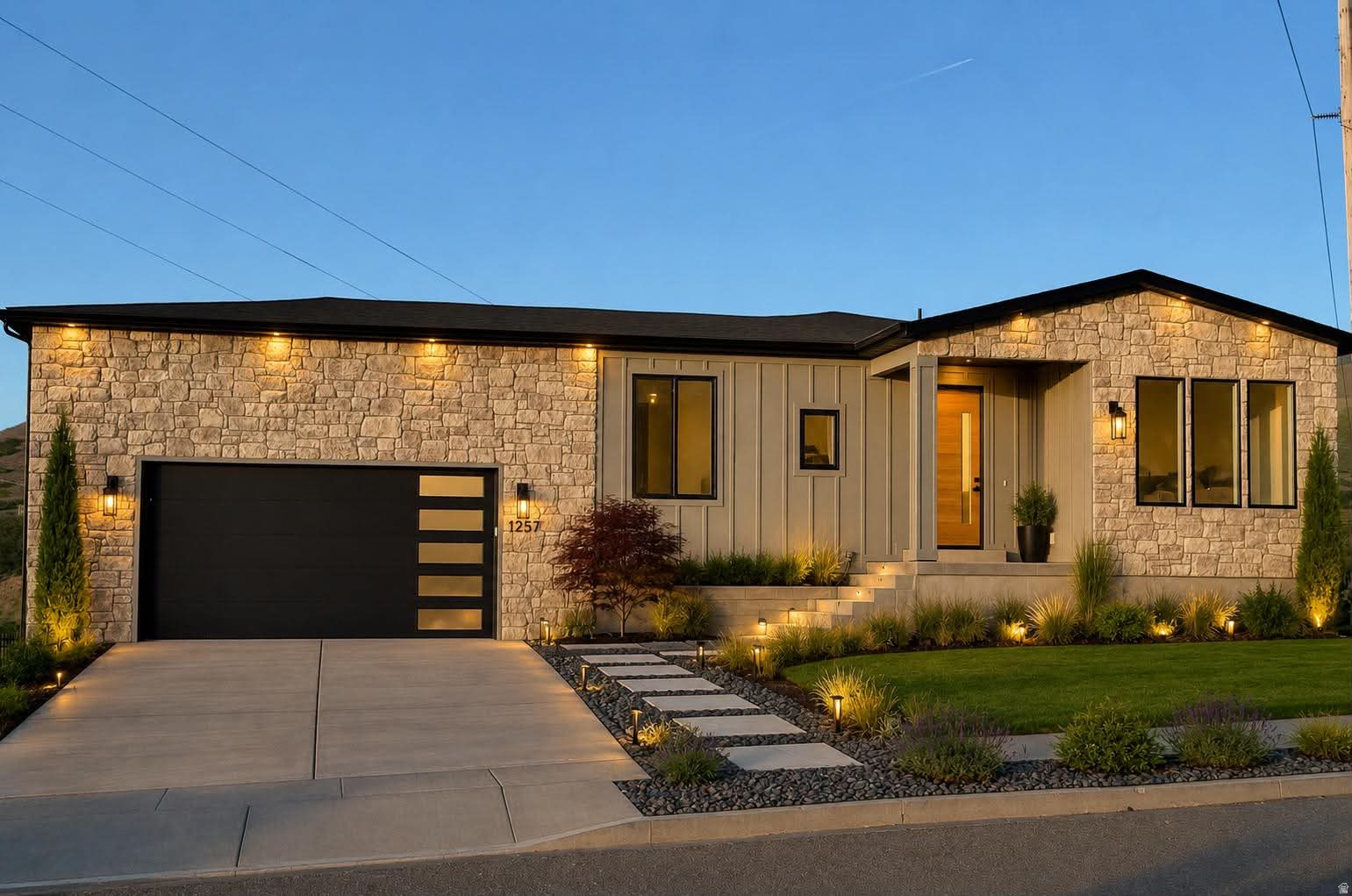 OPEN HOUSE THIS SATURDAY FROM 10AM-12PM!  SELLER OFFERING $20,000 TOWARDS CLOSING COSTS OR RATE BUY DOWN! Nestled at the mouth of scenic Settlement Canyon, this stunning brand-new modern home offers breathtaking lake, mountain, and valley views from one of the highest lots on the street. With 2,589 sq ft of thoughtfully designed living space, this custom home blends luxury, comfort, and incredible scenery. Inside, you'll find soaring vaulted ceilings, a beautiful fireplace, expansive windows, and a custom Brazilian mahogany front door. The kitchen features granite countertops, a gas range with stainless hood, and stylish finishes throughout. A versatile main-level flex room is perfect for a home office, den, or guest space. Additional highlights include 9-ft ceilings on both levels, a tankless water heater, custom tile shower and bath floors, and an oversized 613 sq ft fully insulated garage with an EV outlet. Situated on a spacious 0.36-acre partially fenced lot with a landscaped front yard, this home offers peaceful living just minutes from shopping, dining, and outdoor recreation.