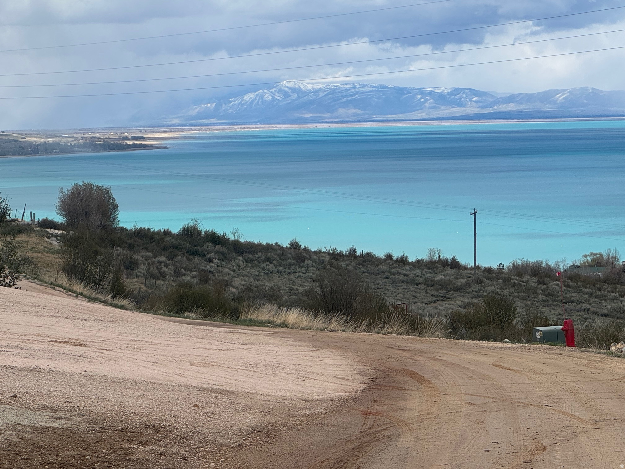 INCREDIBLE, RARE, FRONT ROW RV LOT IN SWAN CREEK VILLAGE!! Has amazing views of Bear Lake and the valley.  Concrete pad, Shed, All utilities.  Seller's 2022 Forest River trailer with several upgrades available separately/optional for the right price. Close to Bear Lake State Park Marina for watercraft launching and downtown Garden City for dining and shops.
