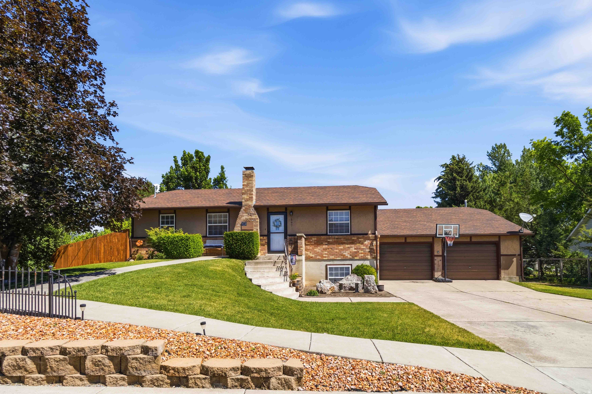 Rare opportunity to own .96 acres in Nibley!  The main level features a kitchen with a center island, abundant cabinetry, and a dining area with deck access. A wheelchair-accessible pathway leads from the driveway to the front entrance, and the upstairs 3/4 bathroom includes a wheelchair-accessible shower entry. Downstairs includes a large family room with a new wood-burning stove and a dry bar. In June 2026, six new windows were installed throughout the home. The property also includes an oversized heated two-car garage with a built-in workbench. Outside, you'll find multiple garden areas, a large fire pit, mature landscaping, RV and trailer parking with nearby power and water access. A standout feature is the large attached outbuilding with tall ceilings, offering storage for ATVs, recreational vehicles, equipment, tools, and firewood. Additional improvements include a horse barn and chicken coop. Buyers are encouraged to verify permitted uses and animal allowances with Nibley City.  Buyer to verify all information.