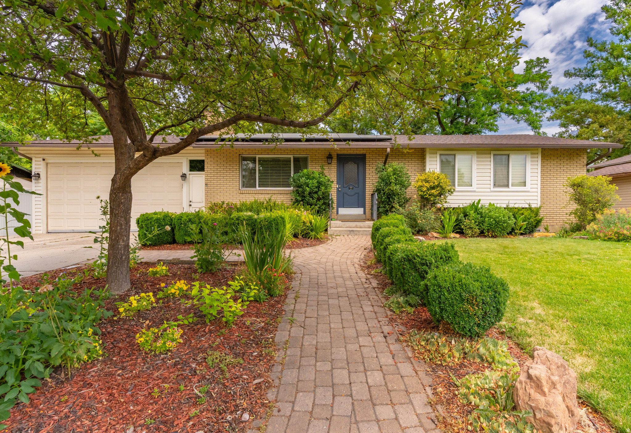 Welcome to this beautifully maintained 4 bedroom, 2 bathroom home, tucked away on a friendly, established street. With unbeatable access to I-15, commuting anywhere in Utah County is quick and convenient while keeping you close to everything you love. Enjoy being just minutes from the excitement of Topgolf, the Megaplex at Vineyard, shopping, restaurants, and all the conveniences of Orem. Inside, you'll find a spacious, functional floor plan with views of the lush yard, a roomy office, two inviting living rooms, a cozy gas fireplace, and a finished basement complete with its own kitchenette-perfect for entertaining, hosting guests, multi-generational living, or creating flexible living space.  The fully fenced backyard has a retreat feel with mature shade trees, vibrant landscaping, raised garden boxes, and a spacious deck for gathering. Energy bill savings are considerable thanks to the solar panels, which are fully paid-off. The spacious garage features an additional work room, providing separate space for projects. This home has been lovingly cared for by wonderful renters who have kept it in exceptional condition and are currently preparing for their move, making this a fantastic opportunity for its next owners.  **Don't miss your chance to see this incredible home in person! Join us for the Open House on Saturday, July 18, from 12:00 PM to 3:00 PM.**