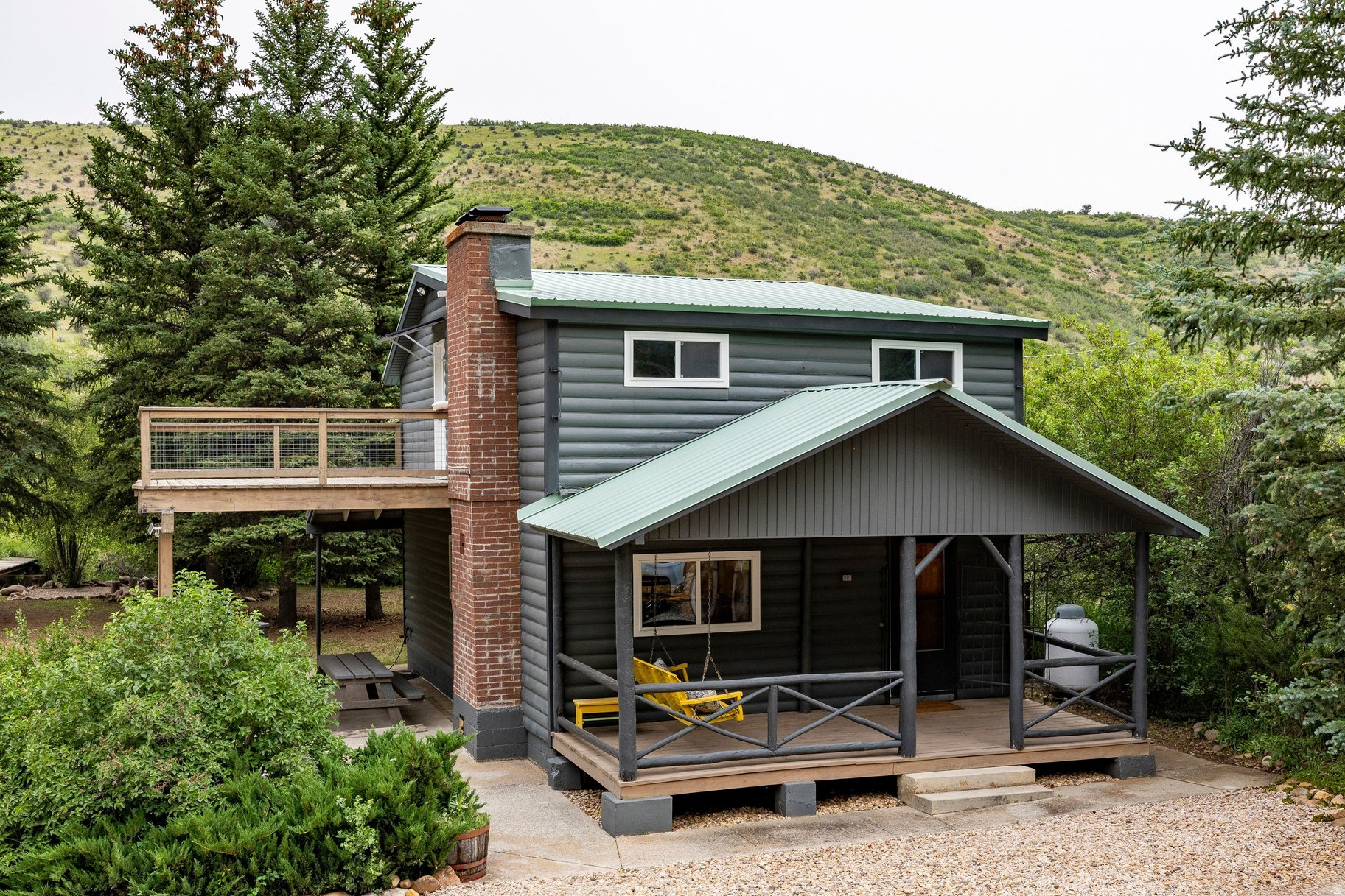 Tucked among the pines on .57 acres in Samak Park, this updated mountain retreat offers the perfect balance of convenience, recreation, and cabin charm. A year-round creek meanders through the property, creating a peaceful setting to enjoy from the spacious deck, whether you're sipping morning coffee or unwinding after a day in the mountains. The cabin has seen numerous improvements, including new windows, new flooring, a remodeled kitchen, a new well and pump, and a new fence, making it move-in ready for weekend escapes, seasonal living, or year-round enjoyment. The functional layout features three bedrooms upstairs and comfortable gathering spaces designed for making memories with family and friends. Located just minutes from Kamas and at the gateway to the Uintas, outdoor recreation is right outside your door. Enjoy easy access to hiking, fishing, snowmobiling, cross-country skiing, hunting, ATV trails, and endless public lands. Park City's world-class skiing, dining, and entertainment are approximately 25 minutes away, while Salt Lake City is less than an hour from the property. Additional highlights include four Beaver Creek well water shares, year-round access, and furnishings included with the sale. Whether you're looking for a mountain getaway, a basecamp for adventure, or a place to unplug and reconnect, this creekside cabin offers an opportunity to enjoy Utah's mountain lifestyle in every season.