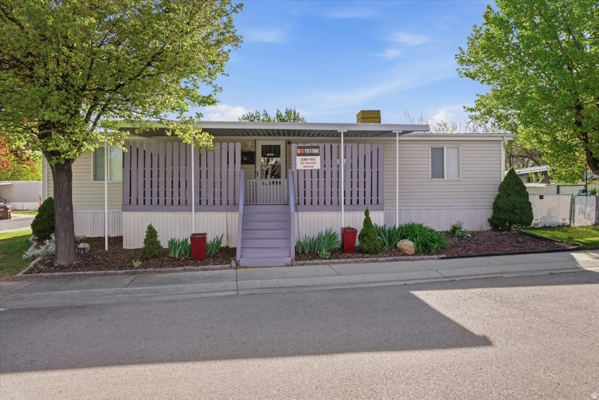 Affordable living in the heart of Sandy with unbeatable convenience and community amenities!  This spacious 3-bedroom, 2-bath double wide offers 1,152 sq ft of comfortable living space with a functional layout and multiple areas for relaxing or entertaining. The home features an updated kitchen, a refreshed primary bathroom with garden tub and tile surround, and two decks-perfect for enjoying the outdoors. Refrigerator is included.  Major updates include a roof replaced in 2021 and a water heater replaced in 2018. The home is equipped with a swamp cooler for A/C and offers comfortable, efficient living.  Step outside to a fully fenced yard with room for pets, gardening, or outdoor gatherings, plus two storage sheds for added convenience. With parking for up to 3 vehicles, this property offers flexibility and ease.  Located in a well-maintained community featuring a clubhouse, pool, and playground, and just minutes from shopping, dining, TRAX, I-15, hiking trails, and world-class skiing.  A great opportunity to own in a prime Sandy location at an affordable price!