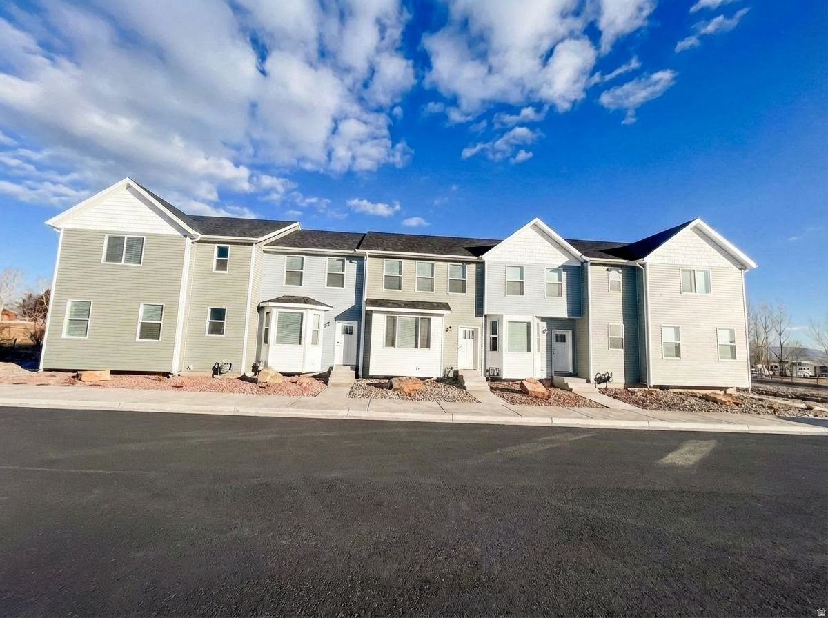 Welcome to this brand-new townhome offering 1,150 sq ft of thoughtfully designed living space with 2 bedrooms and 1.5 baths. Set within a quiet row, the home enjoys beautiful mountain views and a peaceful setting you'll appreciate every day.  The property features xeriscaped landscaping for low-maintenance living and an open patio ideal for relaxing, entertaining, or taking in the surrounding scenery. Open fields to the north and west create a rare sense of space and privacy.  Inside, you'll find an open and functional layout filled with natural light, perfect for modern living. Brand new, beautifully located, and designed for comfort with room to breathe-this townhome offers low-maintenance living in a serene, open setting.  Tax History is based on the lot and not the townhome built on the lot.  Taxes have not yet been assessed for the townhome.  Square footage figures are provided as a courtesy estimate only and were obtained from building plans.  Buyer and buyer agent is advised to obtain an independent measurement.