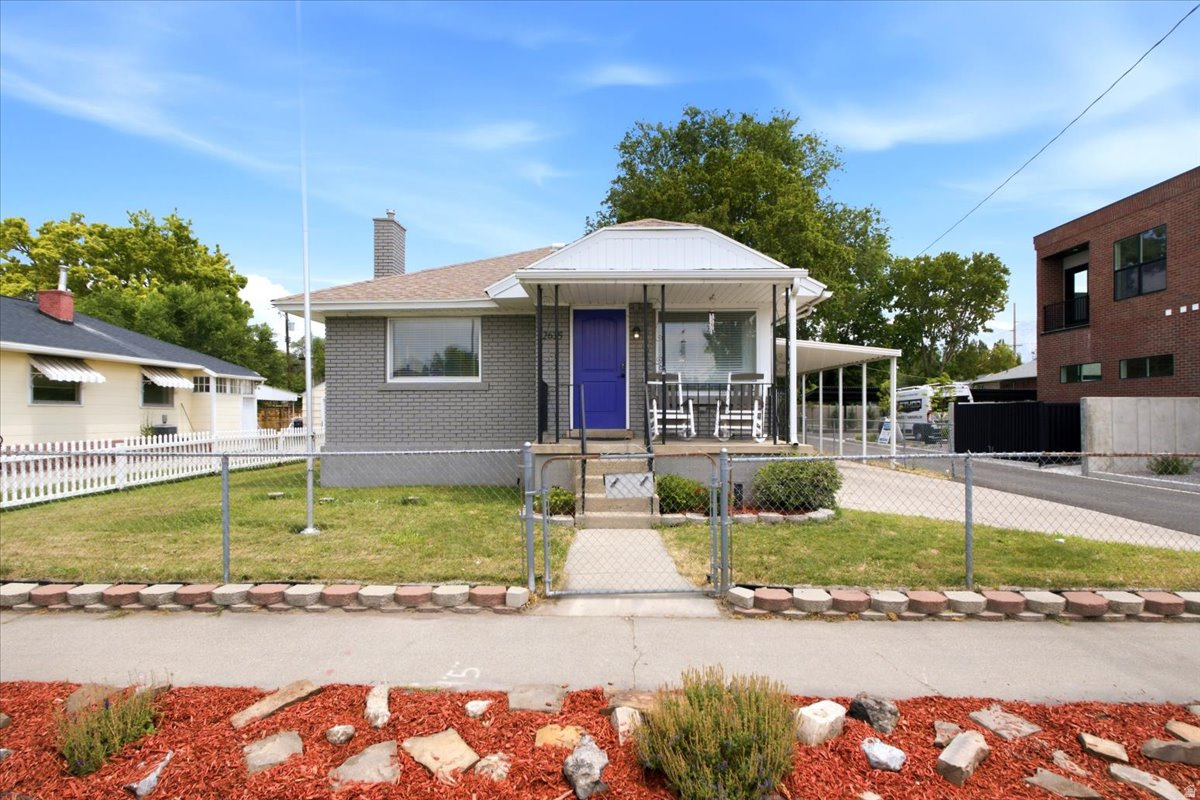 Historic charm meets modern updates in this beautifully renovated home located in one of Salt Lake's most desirable, walkable neighborhoods, just minutes from Liberty Wells, Sugar House, shopping, dining, and commuter access. The functional floor plan offers 4 bedrooms, 2 family rooms, and a bright & inviting finished basement with surprisingly tall ceilings. Parking and storage are exceptional, a rare find in this area, and include an oversized detached garage (approx. 32 feet deep with a 12-foot garage door) with paved access & electrical service, a covered carport & additional driveway parking, RV/trailer parking, and a storage shed with electrical service. Spacious, updated kitchen features new quartz countertops, large single-basin sink, black stainless steel appliances, abundant cabinetry with brass cabinet hardware, and pantry storage. Newer, durable laminate flooring, and newer vinyl windows throughout. Both bathrooms have been tastefully updated with floor-to-ceiling tile surrounds & updated fixtures. Step outside to enjoy a fully fenced backyard with inviting outdoor entertaining spaces: mature shade trees, established gardens, patio, and fire pit area. The charming covered front porch provides another perfect spot to relax and enjoy the neighborhood. Additional upgrades include a high-efficiency furnace (approx. 2016), central air conditioning (approx. 2016), water heater (2020), convenient cartridge-style water softener system, fiber internet, and a programmable sprinkler system with separate front and rear irrigation zones.