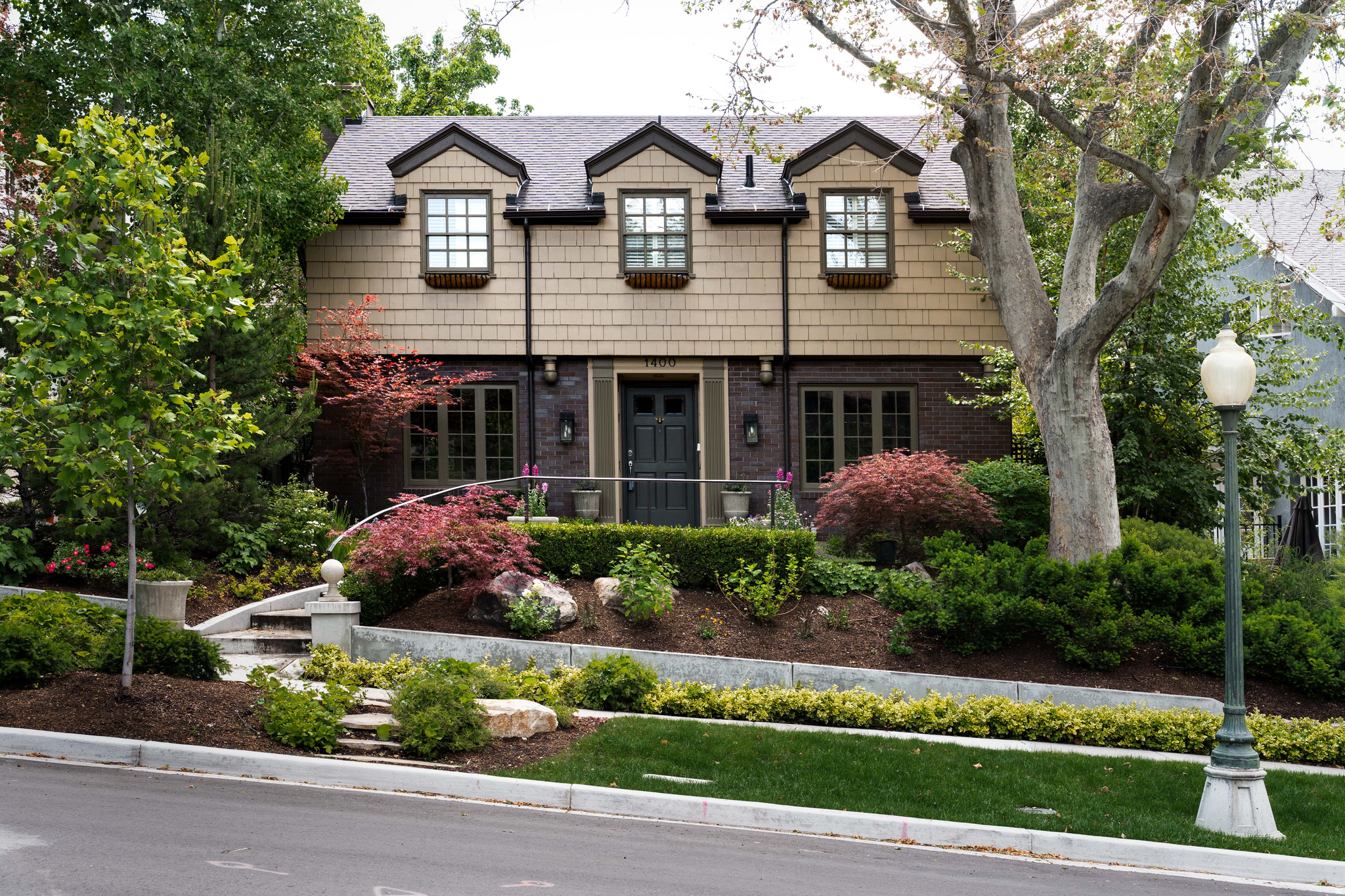 Our homes hold us. They support, shelter and restore us, and nothing could be more true of this residence located among the winding, tree-lined streets of Federal Heights. There's a meditative quality, a tranquility felt the moment you arrive. The landscaped garden and the stately faade, crowned by three gabled dormers, evokes the charm of English-inspired architecture while inside, thoughtfully proportioned spaces create a sense of warmth and elegance. Upon entering, you're greeted with traditional formal living and dining rooms then beyond, at the heart of the home, a wonderfully-renovated kitchen and family room await. Notice the contrast between the formal living room's classic fireplace and the modern iteration in the family room as well as the kitchen's farmhouse-style skirt-front sink to the Wolf range and contemporary cabinets. A main-floor laundry room and adjacent three-quarter bath add convenience and functionality. Perhaps our favorite feature of the home is the covered patio where ivy-wrapped trees provide shade and privacy. It's an intimate space, one that encourages a slowing down. Upstairs, you'll find three bedrooms, 2 full bathrooms and a fourth bedroom in the lower level. The property is fully fenced and includes a two-car garage accessed from a private alley. Several parks lie within walking distance, and the location offers exceptional proximity to the University of Utah campus, including its renowned hospitals and research facilities. Beautifully maintained and thoughtfully updated, this Federal Heights home is a rare find and one that is sure to not last on the market for long.