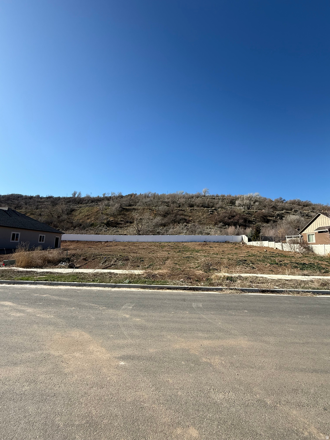 Rare opportunity to build a custom home with exclusive builder McFarland Homes in one of South Weber's most desirable neighborhoods. This .28-acre lot sits in a subdivision of beautiful custom homes and offers a peaceful setting with no possibility for backyard neighbors.  Located away from the freeway and outside of South Weber's well-known wind tunnel, the lot provides a quiet, comfortable environment while still offering quick access to shopping, dining, and daily conveniences. Enjoy beautiful mountain views, nearby schools, parks, and outdoor recreation in a location that feels private yet close to everything. www.mcfarlandcustomhomes.com