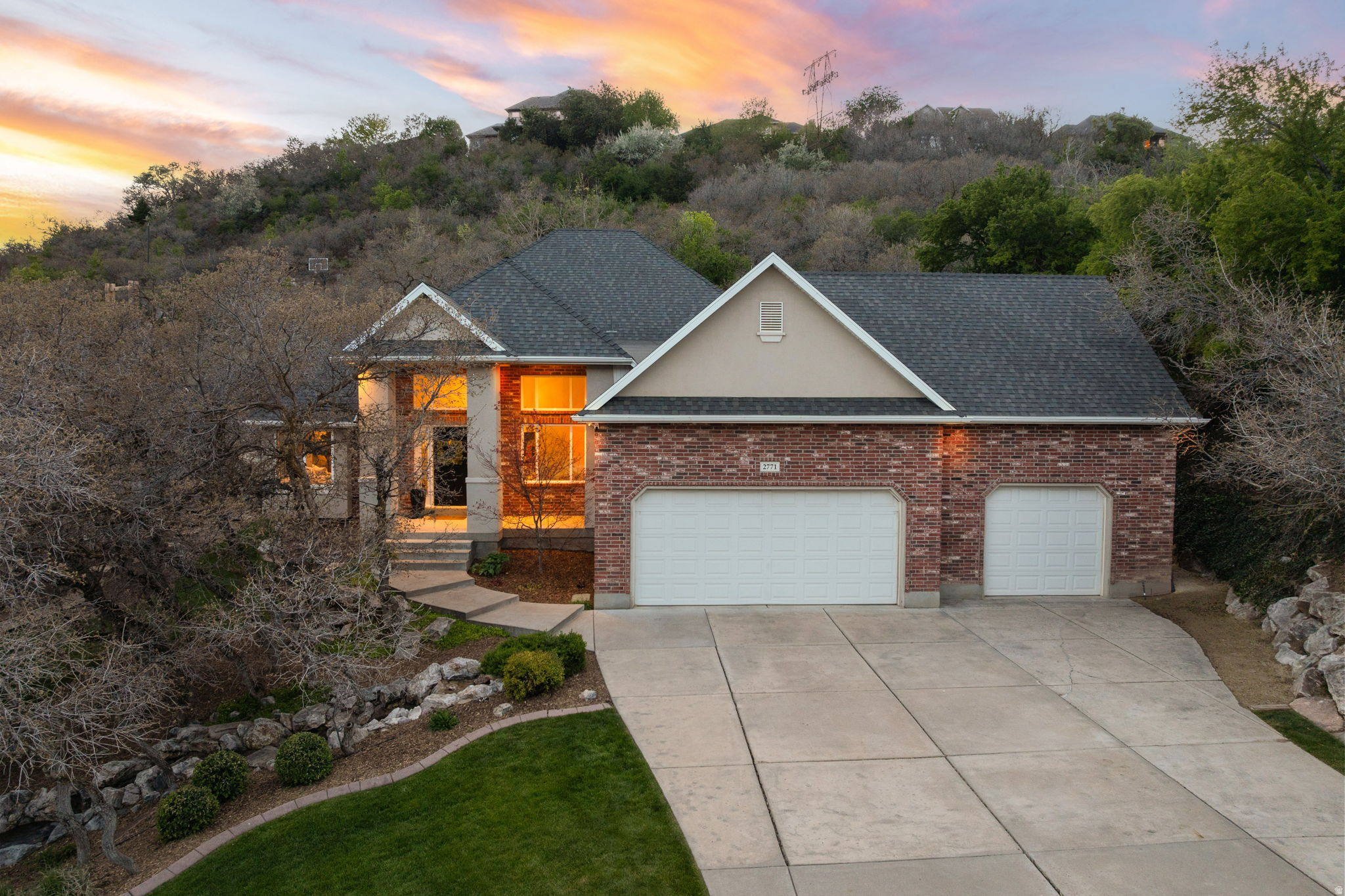 *A Timeless Mountain Retreat on Layton's Coveted East Bench* Tucked into the Wasatch foothills on a lush, private .78-acre lot among towering oaks, this 4,244 square foot rambler offers a one-of-a-kind setting and the kind of unquantifiable charm you simply can't manufacture. A stunning 30-foot cascading water feature greets you at the entry, setting the tone for what lies beyond. Inside, soaring cathedral ceilings, true main-level living, and a dramatic grand staircase sweeping down to an expansive walk-out basement create a home that's as elegant as it is inviting. Five spacious bedrooms, three beautifully appointed bathrooms, a 3-car garage, and the practical luxuries of a brand-new roof, dual water heaters, and dual furnaces round out 12 years of meticulous, tasteful updates. Outside, the magic continues - two covered patios, a private deck nestled among the oaks with panoramic views, four raised garden beds in the Upper Garden, and an upgraded French Drain System throughout the thoughtfully designed landscape. The lifestyle? Just as captivating. Snowbasin Resort is 9 miles away for year-round adventure, Pineview Reservoir is 13 miles out for summer days on the water, and Kay's Creek Trailhead sits just steps from your door - a scenic 2.4-mile loop leading to Hobbs Reservoir's stocked trout. This isn't just a home. It's a sanctuary you have to experience to truly understand.