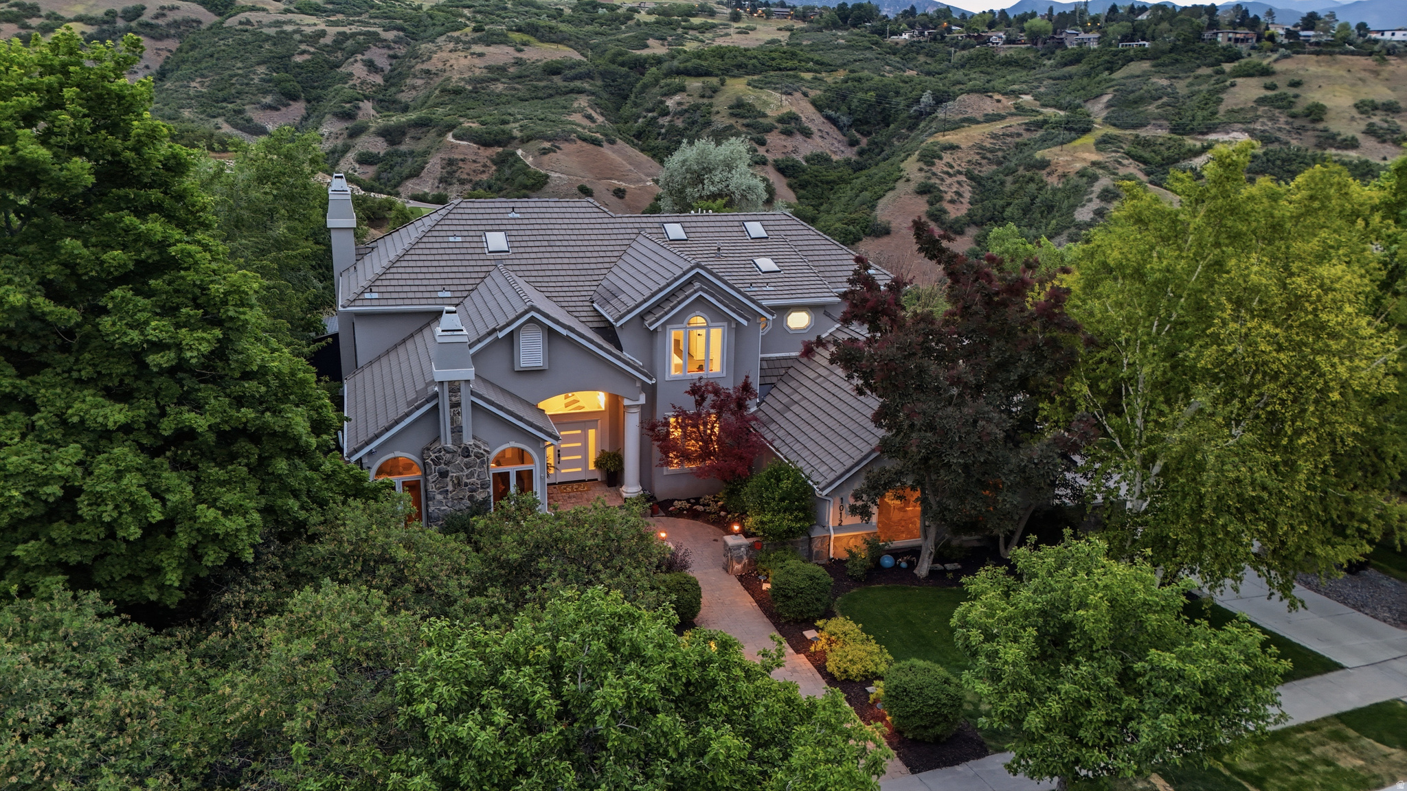 Where City Creek Canyon meets the lights of downtown, a residence backing directly to the City Creek Canyon, framed by the Wasatch Range and the glittering valley below. Reimagined top to bottom, this turnkey home leaves nothing for the next owner to finish. Wood-look tile with radiant in-floor heat flows across a main floor opened up by a raised, now-level living room. Windows replaced, bathrooms updated, modern lighting and a hard-wired security system. A new 1,200 sq ft composite deck captures the view from morning to nightfall. Below, a fully renovated basement adds finished living space and abundant storage. A finished, move-in-ready home in one of the city's most coveted settings.