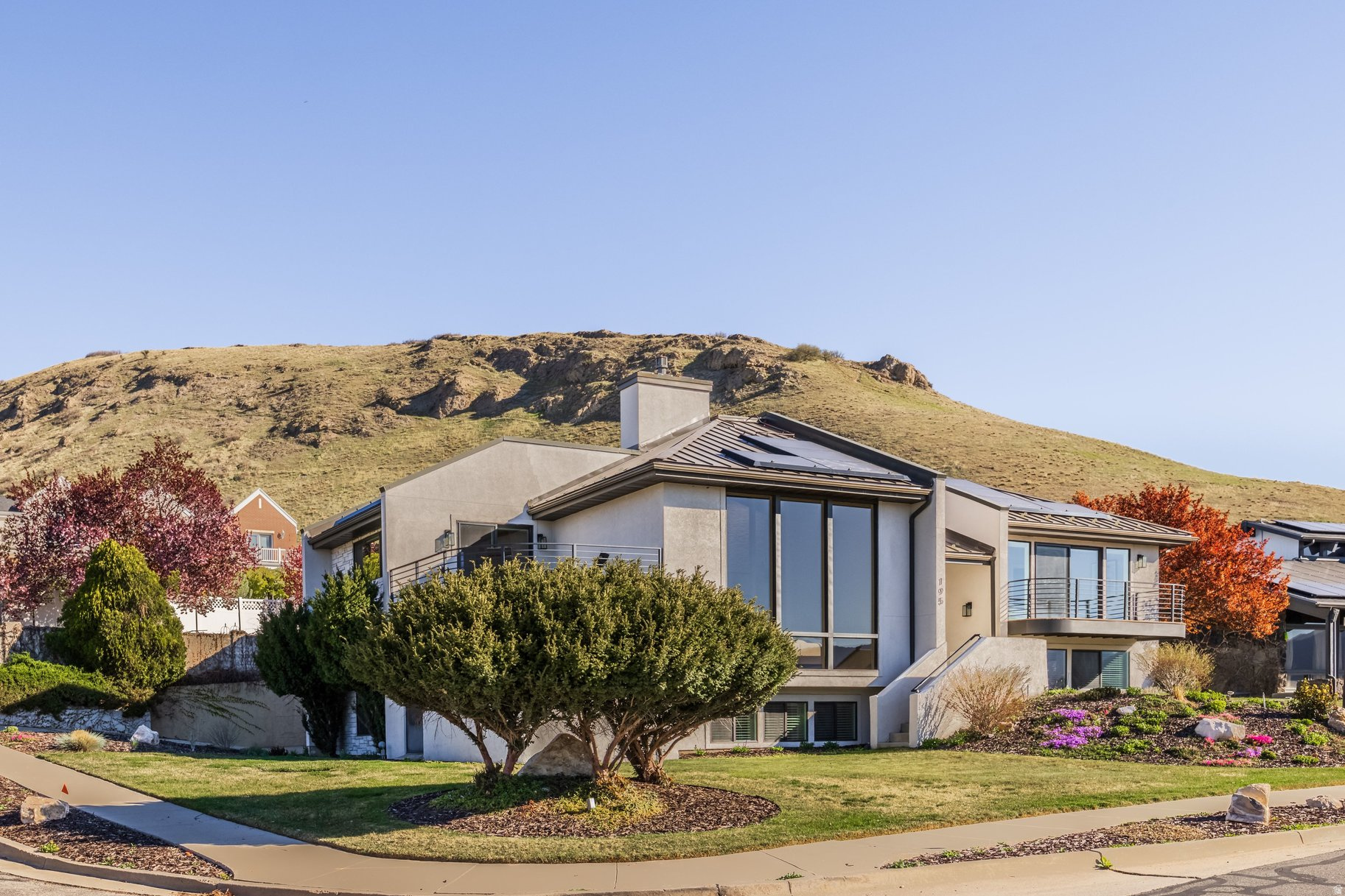 ***OPEN HOUSE THIS SATURDAY 6/20 FROM 2:30-4:30PM! *** Perched in the highly sought-after East Capitol neighborhood just above downtown Salt Lake City, this beautifully renovated home offers the perfect blend of modern comfort and scenic beauty.  Fully renovated from top to bottom, the residence features five spacious bedrooms and 4.5 bathrooms, along with a thoughtfully designed open floor plan ideal for both everyday living and entertaining.  The inviting interior flows seamlessly into multiple gathering spaces, creating a warm and functional layout. Step outside to a rare, flat backyard complete with garden space and a patio-perfect for summer evening dinners under the stars. The front balcony welcomes you with a cozy fire pit, where you can relax and take in stunning views of the downtown skyline.  Stunning primary suite serves as a private retreat, featuring its own balcony with sweeping views of downtown and the Wasatch Mountains. Additional highlights include High end appliances, hot tub, solar panels and electric vehicle charging stations, adding efficiency and convenience to this exceptional home.  Ideally located within walking distance to Ensign Downs Park-offering a playground, soccer field, and tennis courts-and just minutes from hiking trails like City Creek Canyon and Ensign Peak  where breathtaking panoramic views of the valley await. This is city living at its finest, with nature right at your doorstep.
