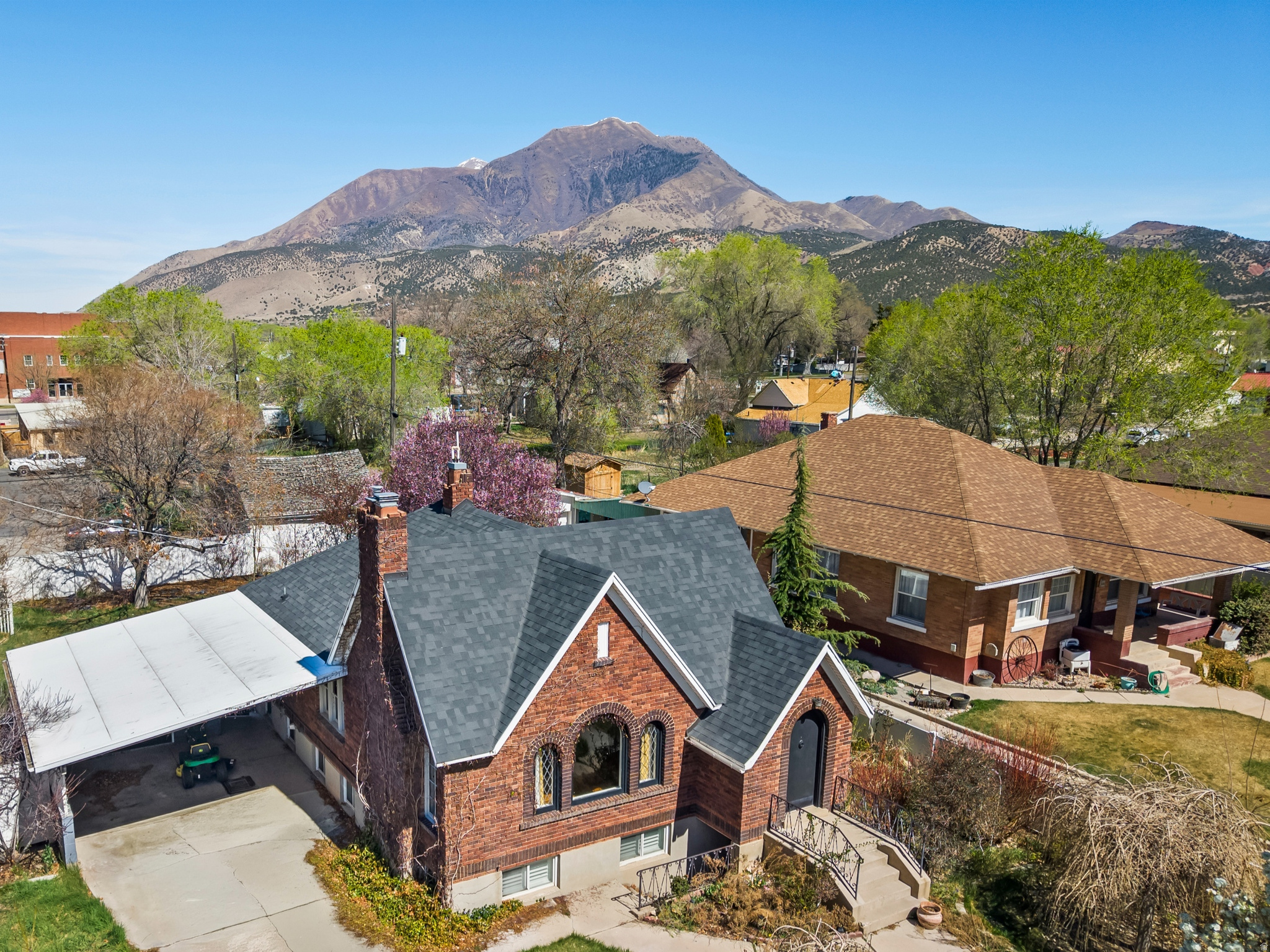 NOTICE: No trespassing. All showings must be scheduled through the listing agent. Do not approach the home or walk the property without prior approval and an agent present. Opportunities like this do not come around often. Located in the Central Commercial (CC) zone in the heart of downtown Nephi, this property offers true mixed-use potential. Currently used as a residence, it opens the door to a live/work lifestyle where you can run a business while enjoying the comfort and charm of home all in one place.  The 1940s Tudor-style design brings undeniable character with its gable rooflines, arched doorways, and storybook curb appeal, creating a warm and inviting space that stands out for both residential living and business presence. Inside, the home offers a spacious and functional layout with multiple bedrooms, flexible living areas, and a basement with a separate exterior entrance, ideal for separating personal and business spaces if desired.  The CC zoning allows for a wide range of uses, making this an ideal setup for those looking to combine lifestyle and livelihood. Some of the most fitting live/work opportunities for this property include a boutique retail shop, art gallery or studio, professional office space, counseling or therapy services, salon or spa, bakery or small caf setting, photography studio, instructional or creative academy, specialty craft or hobby shop, or a small business storefront with residential living.  The private, fully fenced yard with mature landscaping and pergola adds an extra layer of versatility, offering space for outdoor gatherings, client experiences, or simply a peaceful retreat at the end of the day.  Positioned within walking distance to local shops, restaurants, the coffee house, post office, county offices, and the DUP museum, the location supports both strong visibility and everyday convenience.  Whether you are looking to create a unique business presence, invest in a flexible property, or enjoy the benefits of living where you work, this property delivers character, location, and opportunity all in one.