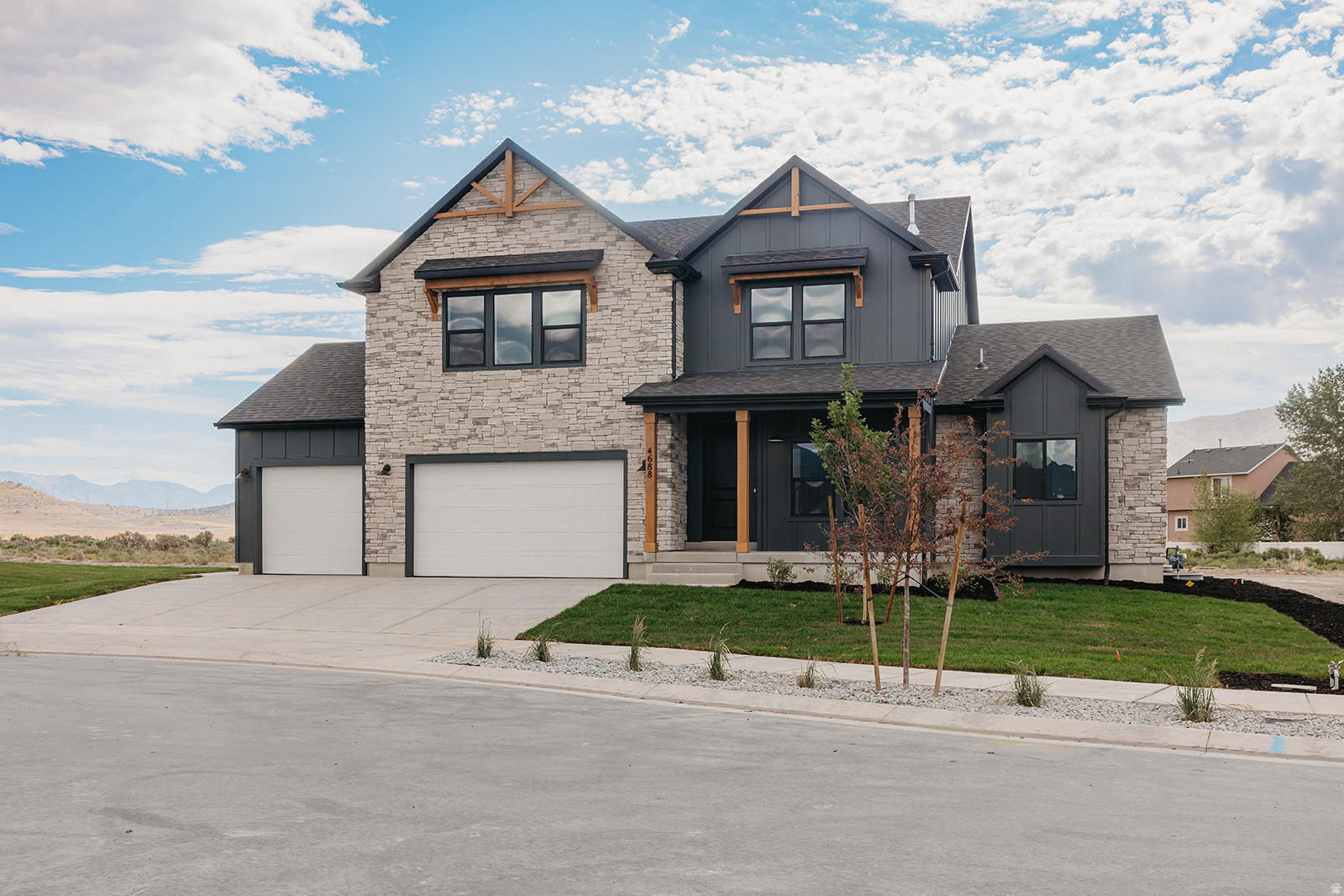 ** HUGE PRICE DROP** OPEN HOUSE SATURDAY 7/11- 12p-4p** Welcome home to this thoughtfully upgraded 2-story, set on a large .30-acre lot where mountain views meet meticulous craftsmanship. This home features a primary suite on the main floor and a fully finished basement, boasting over $200,000 in premium upgrades throughout for the perfect blend of style and function. 9' ceilings span both the main and basement levels, with 20' ceilings in the living room, creating an open, airy feel from top to bottom. The gourmet kitchen is a showstopper, featuring quartz countertops throughout with an upgraded thicker edge detail, plus a double oven ready for effortless entertaining. Durable, low-maintenance LVP flooring flows through main living areas, complemented by plush carpet in bedrooms and living spaces for added comfort. Cozy up by the fireplace on chilly evenings, and enjoy the modern, open-concept feel of sleek open railing throughout. Outside, striking exterior stone accents and sophisticated black exterior windows give this home standout curb appeal. The 3rd car garage offers extra space for vehicles, toys, or storage. Enjoy incredible community amenities including 1-gig internet, pool, clubhouse, and fitness center - all just minutes from parks, schools, and popular restaurants. With unbeatable mountain views, a main-floor primary suite, a finished basement, and top-to-bottom upgrades, this home is truly move-in ready and won't last long. Schedule your showing today!