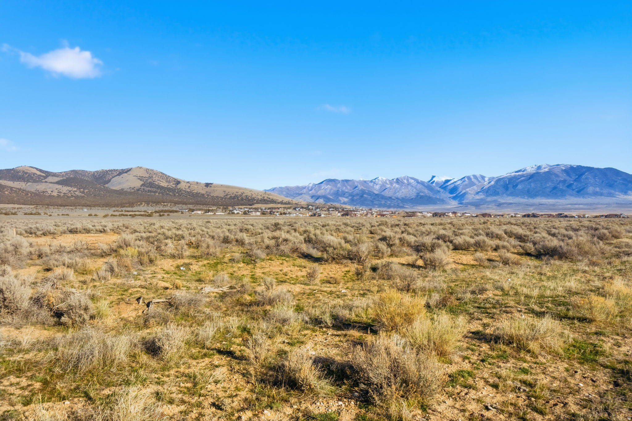 Incredible opportunity for builders and developers to acquire 225 fully entitled one-acre estate lots in the newly approved South Rim West subdivision, located in the desirable South Rim area of unincorporated Tooele County. Phase 1 is fully engineered, final plat approved, and construction-ready, with grading, drainage, utilities, and street plans complete. The subdivision is approved for five phases, with all entitlements in place, offering zero entitlement risk and flexibility for immediate or phased development.   A 1,000,000-gallon water tank is currently in the bidding and pre-construction phase, representing a significant infrastructure investment to support the community's long-term water needs. Each homesite is planned as a true one-acre estate lot, with propane and septic systems utilized throughout, consistent with rural estate living.  The community design incorporates creek corridors, open space, and efficient road layouts, creating a thoughtful framework for future residential development. Located approximately 50 minutes from Salt Lake City, the South Rim area continues to experience steady growth and in-migration, making this one of the last large-scale, fully entitled estate-lot subdivisions available in the region.