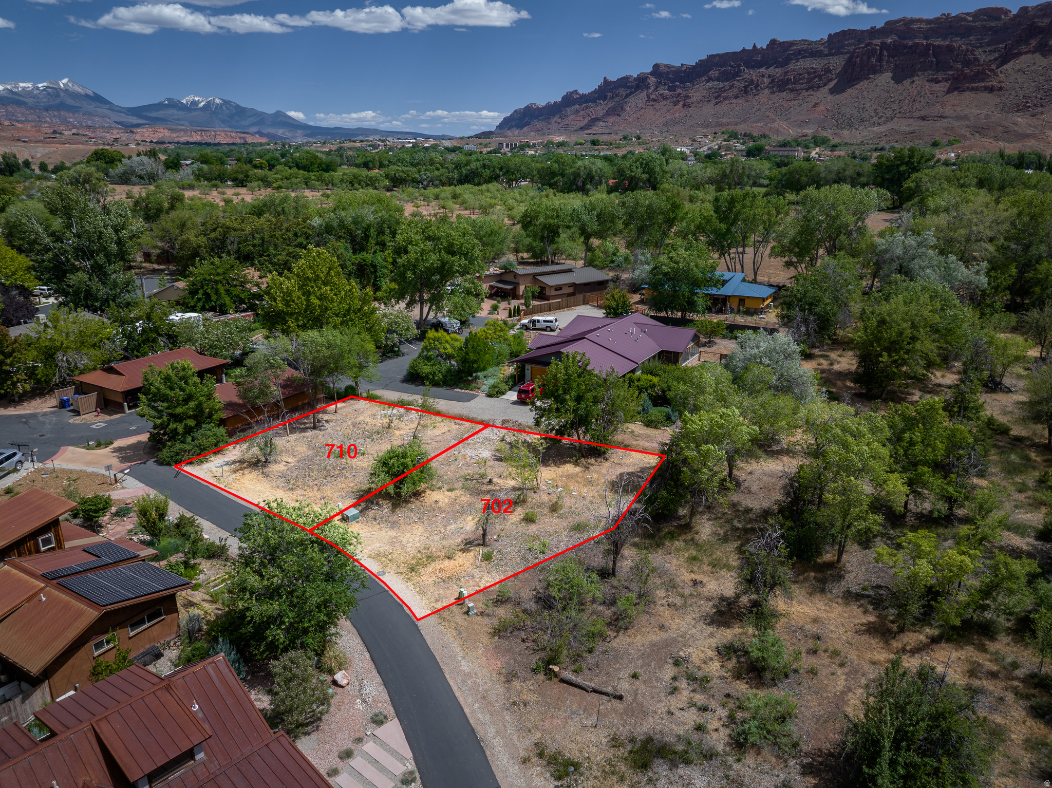 ECO-CONSCIOUS MOAB LIVING - Rare opportunity to build in the thoughtfully designed Mulberry Grove community. This twin-home lot has two .11 acre lots totaling .22 acres nestled within one of Moab's most unique pedestrian-friendly neighborhoods, located near Rotary Park, the Mill Creek Parkway, and the riparian corridor. Designed with sustainability and connection in mind, Mulberry Grove features 11 acres of preserved open space including community orchards, gardens, green space, and strollable pathways that create a true neighborhood feel. Residents enjoy access to the Mill Creek paths to downtown Moab while embracing a quieter, more intentional style of living. These lots are drive-in lots, offering the ability to build carports or garages, as well as site plans available with designs for both homes.  Utilities are available, and the lots are ready for your vision in this distinctive community that blends modern sustainability in the natural surroundings creating a harmonious neighborhood with unique charm. The seller is open to financing qualified buyers directly, removing the need for a traditional land loan.