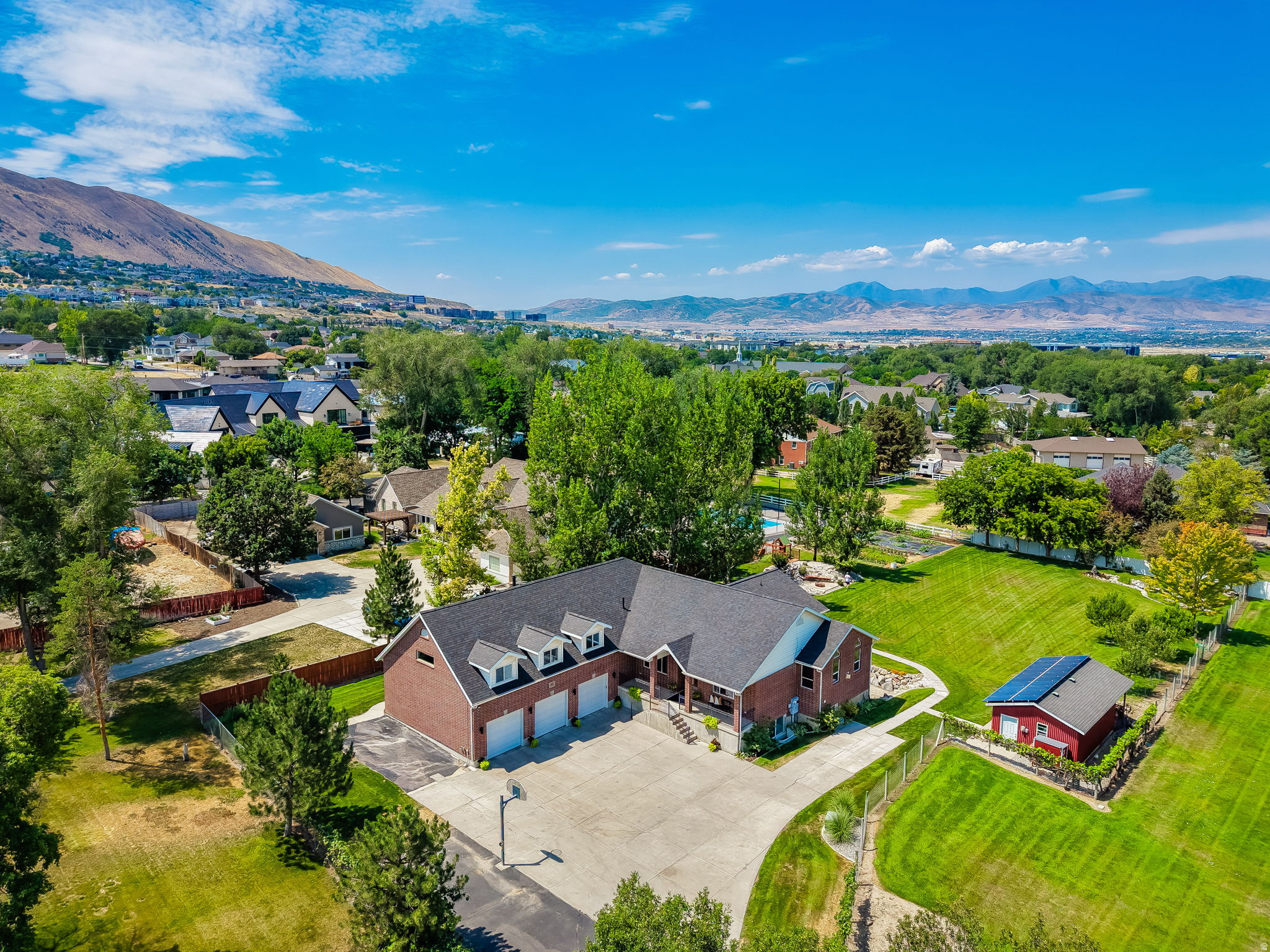 ""Rare opportunity to own a private estate on nearly ONE ACRE in the heart of Draper! Tucked away on a private lane off Fort Street, this impressive 6,171 sq. ft. home offers breathtaking mountain views, exceptional privacy, and room for everyone. Featuring 7 bedrooms, 4 bathrooms, a heated 3-car garage, radiant in-floor heating, and numerous recent updates including a new roof, new carpet, and fresh paint, this property combines comfort, functionality, and versatility. The spacious floor plan includes large gathering areas, abundant natural light, a bonus room above the garage with a theater setup, wet bar and generous storage throughout. The fully equipped basement apartment features a separate entrance, 2 bedrooms, 2 bathrooms, a full kitchen, and laundry, making it ideal for multi-generational living, guests, or rental income potential. Situated on nearly an acre, the outdoor space is equally impressive with mature landscaping, fruit trees, garden areas, water features, irrigation water, RV parking with power hookup, sewer dump station, hobby shed, chicken coop, zoned for horses and plenty of room for entertaining, recreation, or future possibilities. Enjoy the peace and privacy of country-style living while being just minutes from shopping, restaurants, schools, parks, hiking and biking trails, and convenient freeway access. Properties offering this combination of space, privacy, views, and versatility are a rare find in Draper.