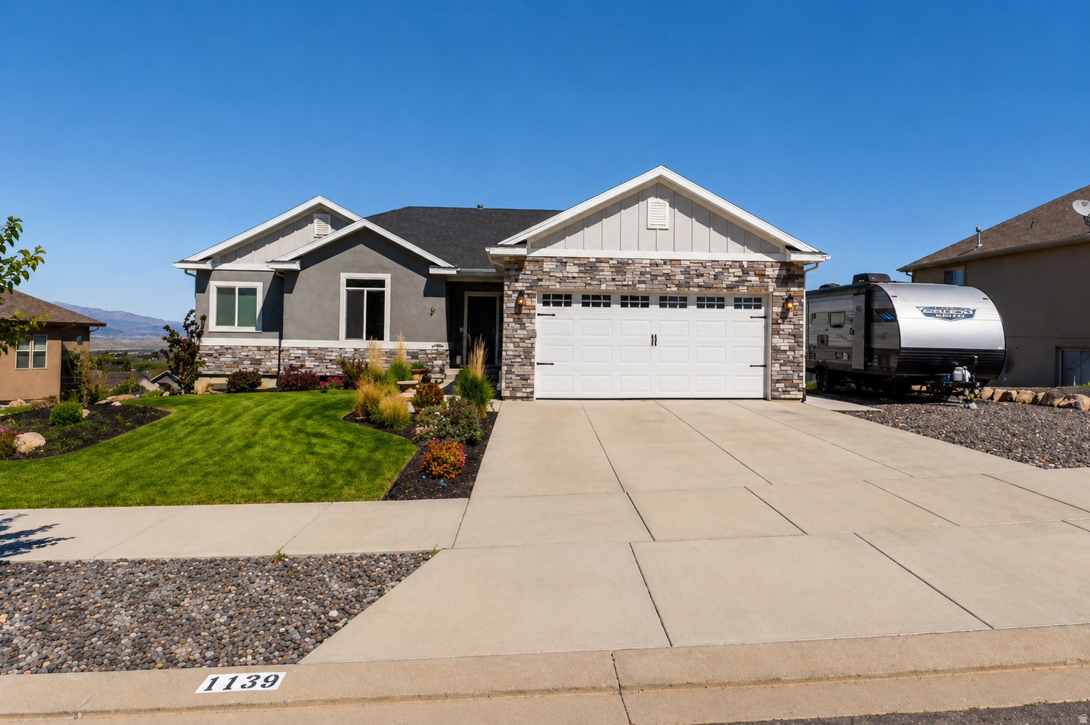 Welcome to this exceptional 5-bedroom, 3-bath home offering 3,674 square feet of thoughtfully designed living space on a .21-acre lot. Enjoy breathtaking valley views from a property that perfectly blends comfort, functionality, and income potential.  Built with quality in mind, this home features durable 2x6 exterior walls, a suspended slab foundation, and a walk-out basement that maximizes both space and natural light. Inside, you'll find spacious bedrooms, custom blinds throughout, and elegant granite countertops that add a touch of luxury to the kitchen and living areas.  A standout feature is the approximately 1,600 sq ft apartment-ideal for mother-in-law aprtment, multi-generational living, Airbnb, or long-term rental income to help offset your mortgage. The home also includes a large storage area that could easily be converted into a theater or recreation room, giving you flexibility to fit your lifestyle.  Stay comfortable year-round with an advanced tankless water heater providing instant, continuous hot water, along with a high-performance water softening system designed to handle Utah's mineral-rich water. Washer and dryer hookups are conveniently located both upstairs and downstairs.  Outside, you'll find RV parking, a storage shed, and easy freeway access for commuting convenience, all while enjoying a peaceful setting with stunning views.  This home truly offers space, versatility, and opportunity-whether you're looking to expand, invest, or simply enjoy elevated living. There are 2 tours above, one is a 3d tour and the other is a video walk through tour.